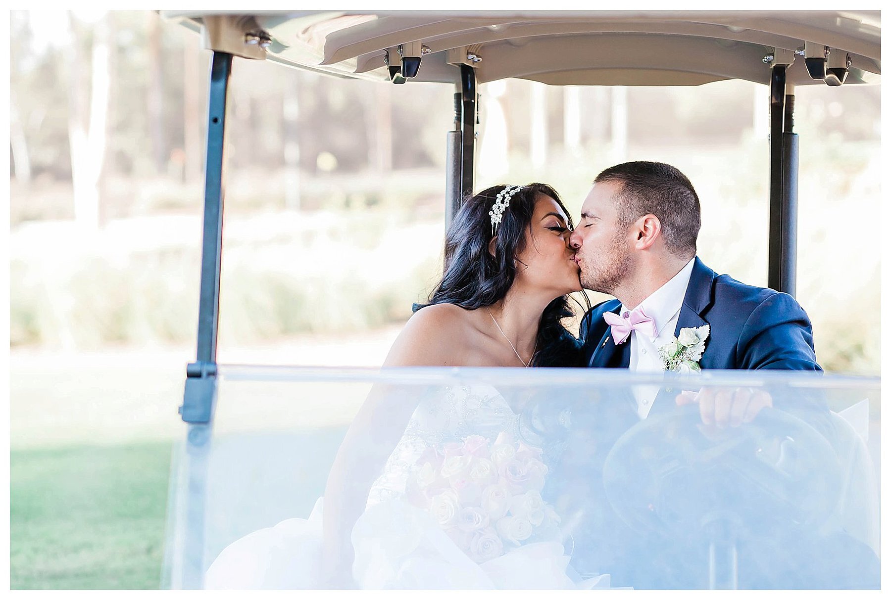  bride and groom kiss in a golf cart 
