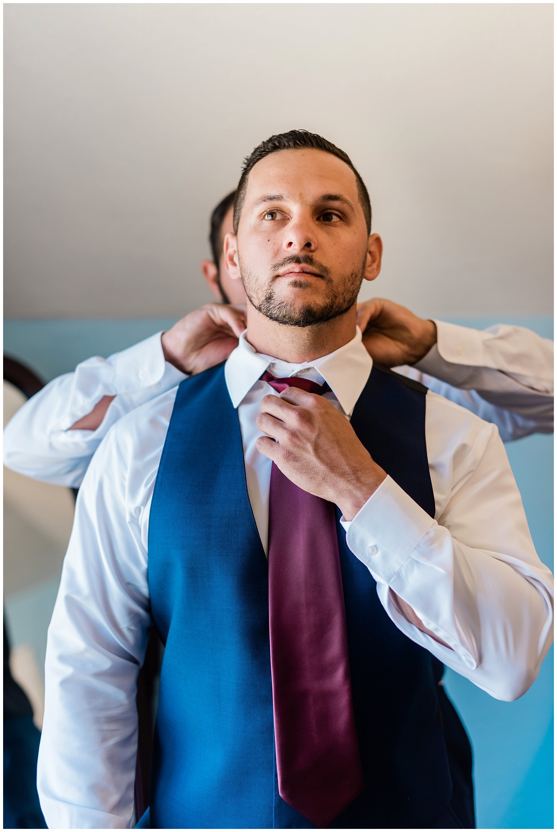  groom getting ready in the groom’s suite 