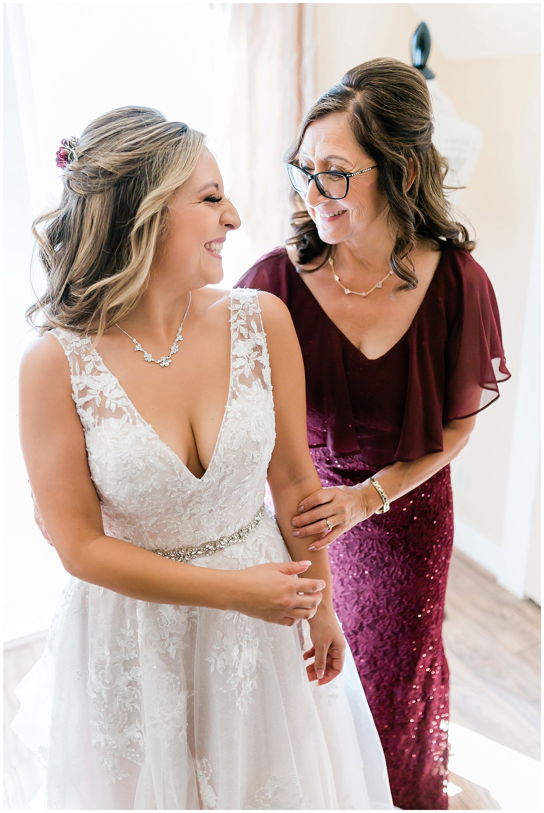  bride and her mother smiling and laughing 