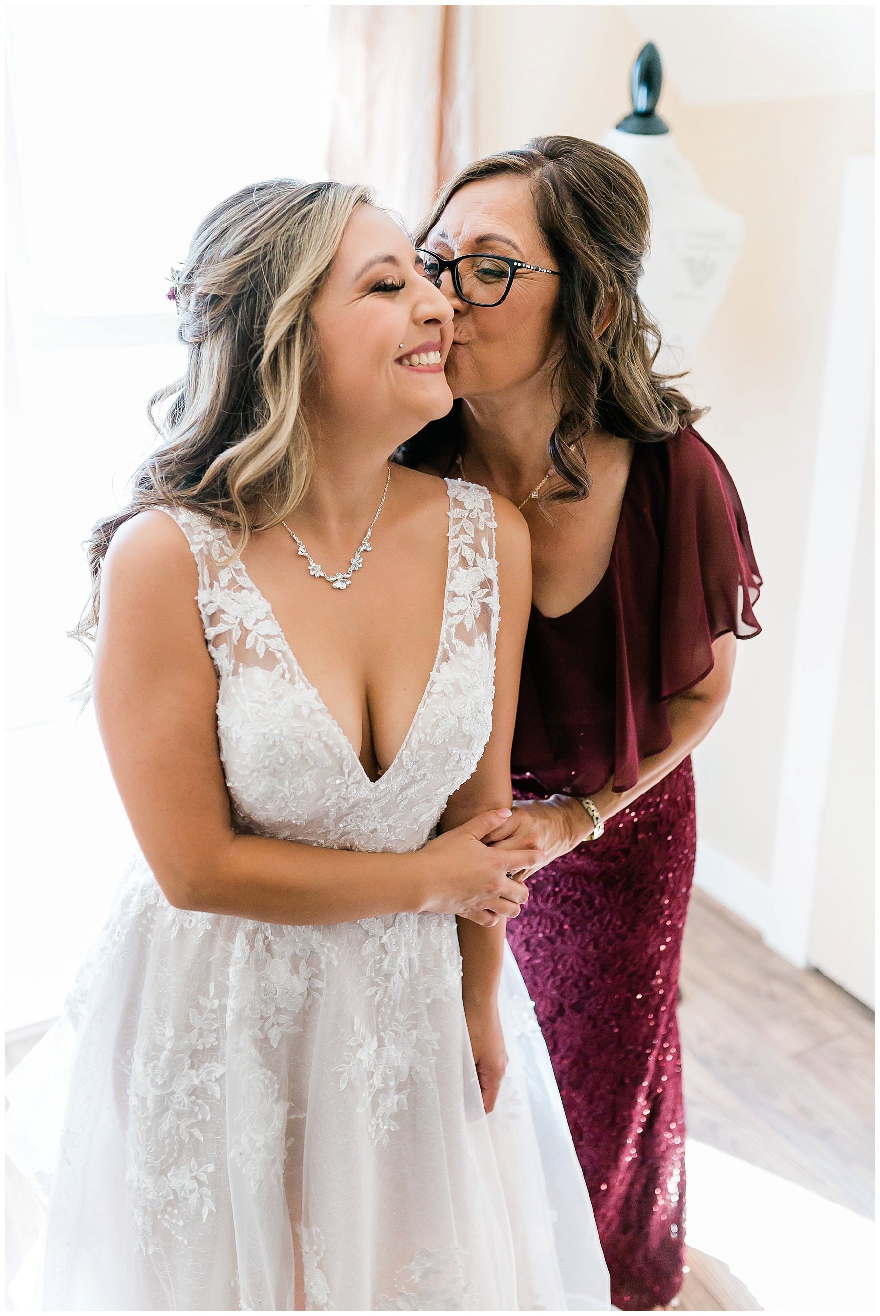  bride and her mother smiling and laughing 
