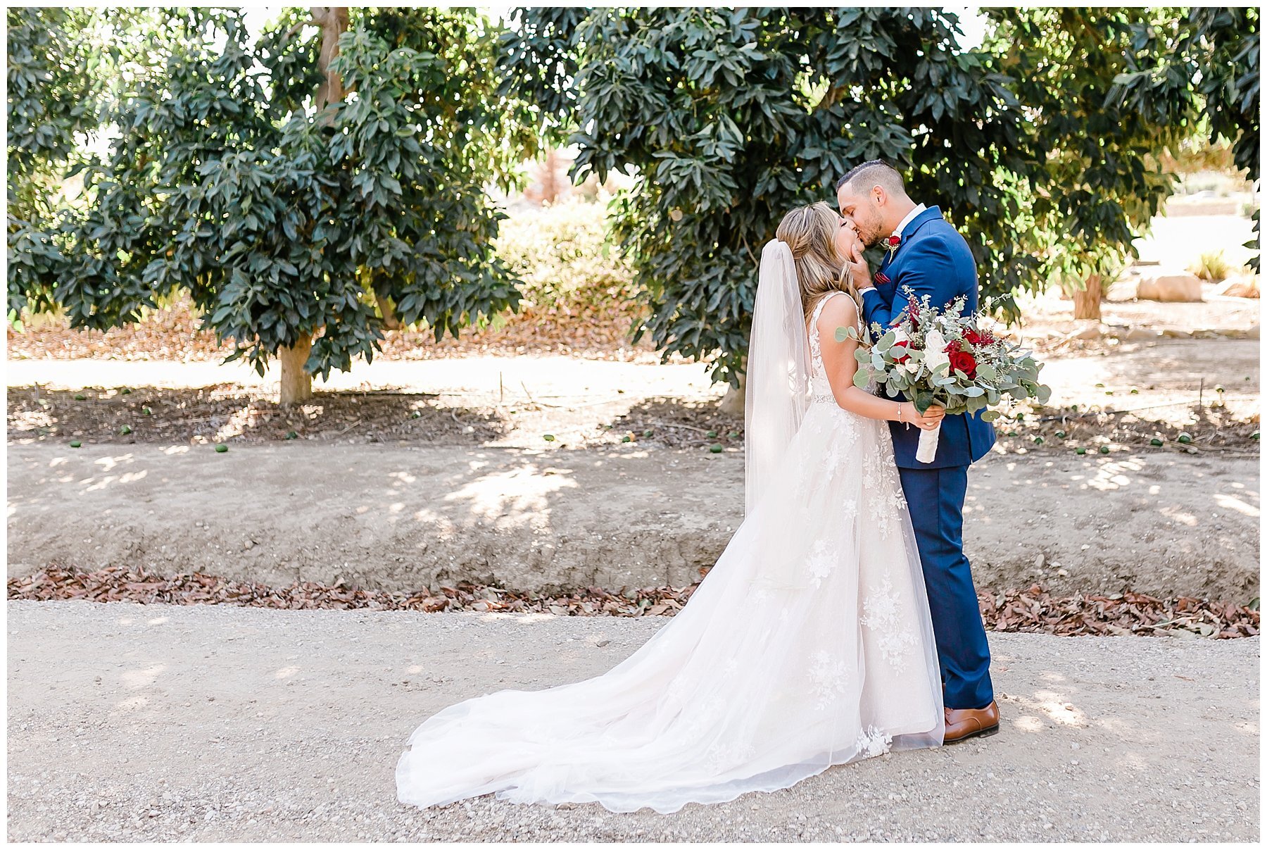  bride and groom kissing on a pathway at the ranch 