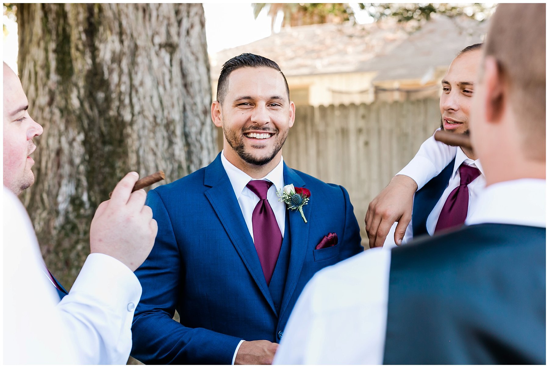  groomsmen in front of the tree and fence 