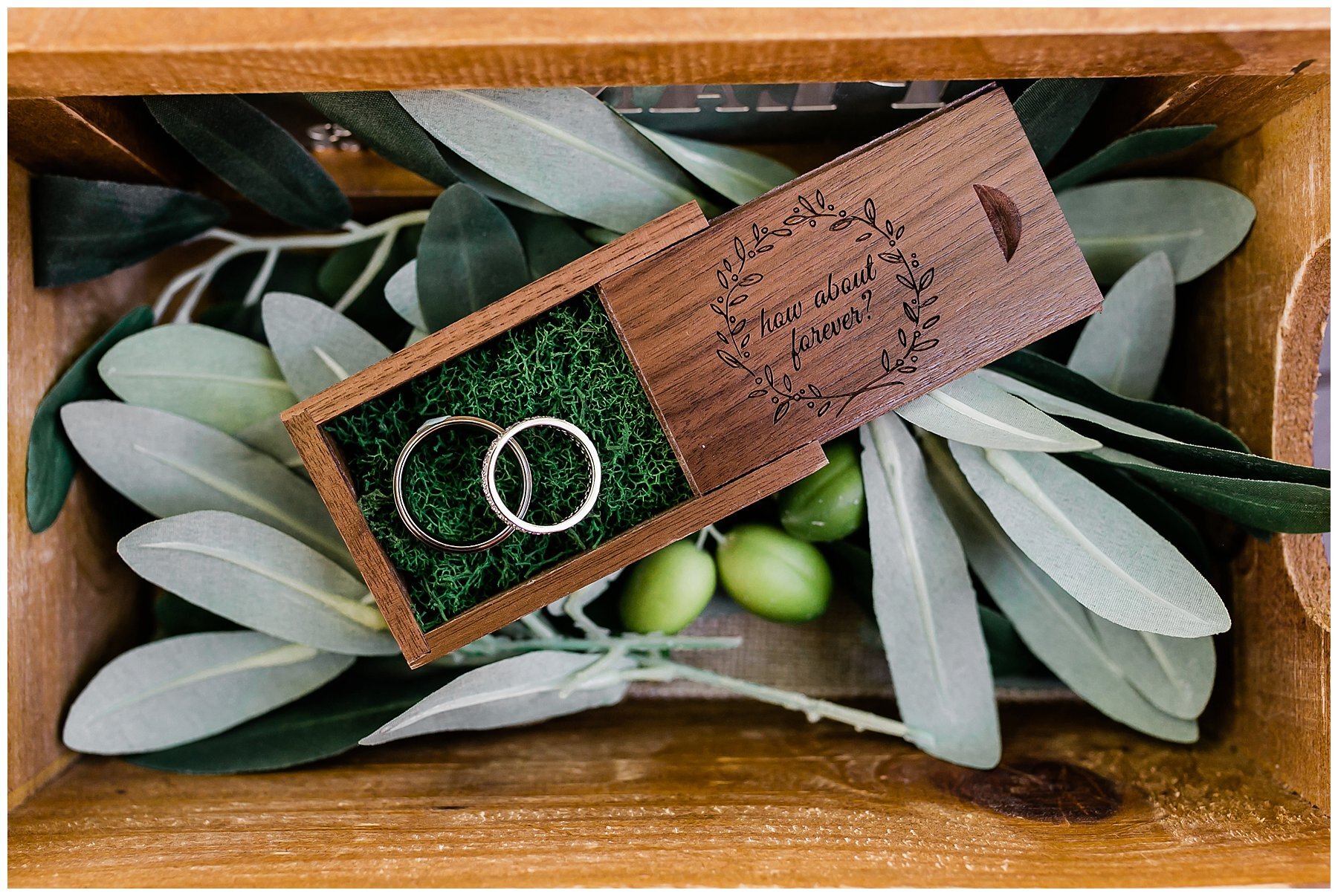  wedding rings in the box on top of leaves 