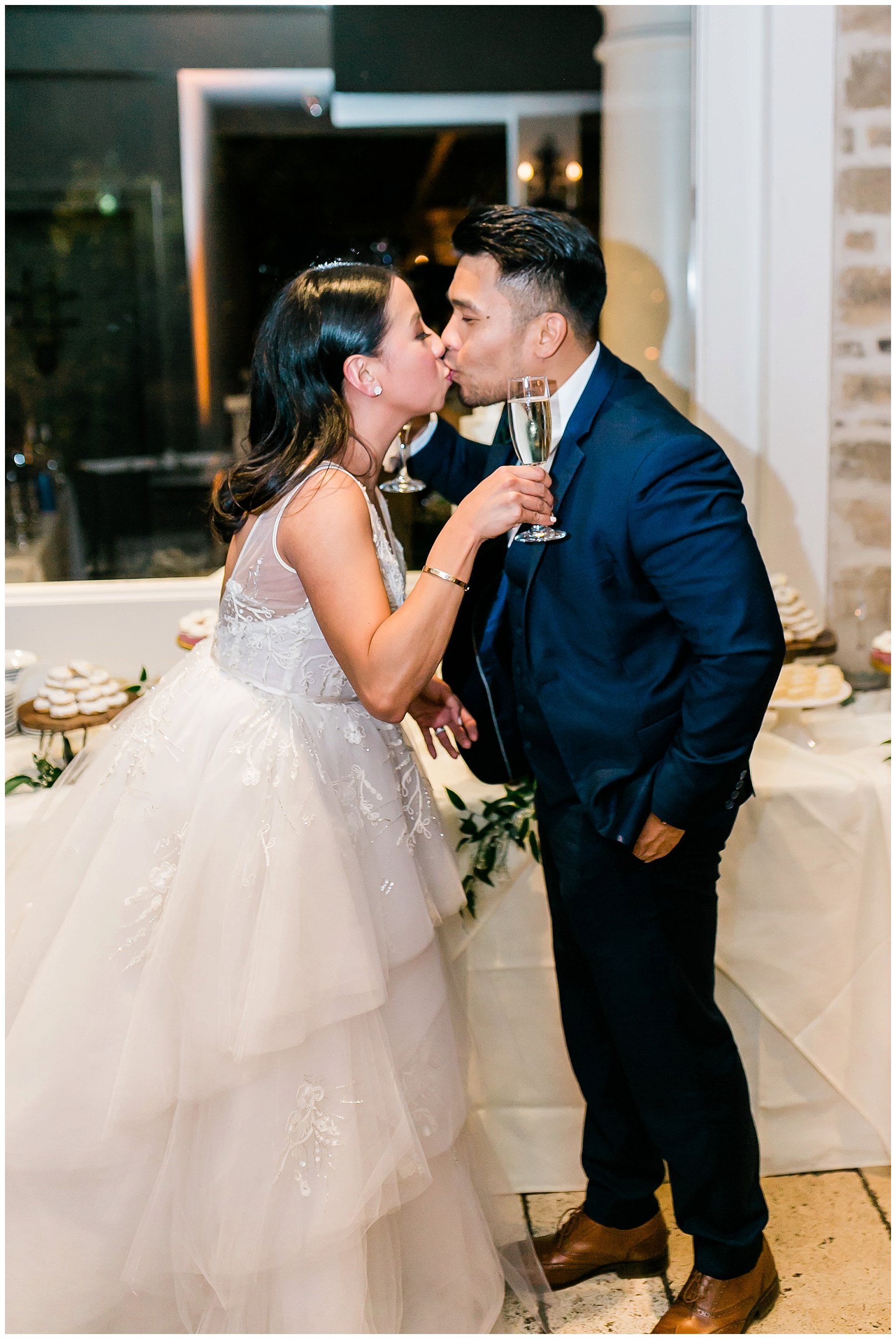  bride and groom kissing at the reception 