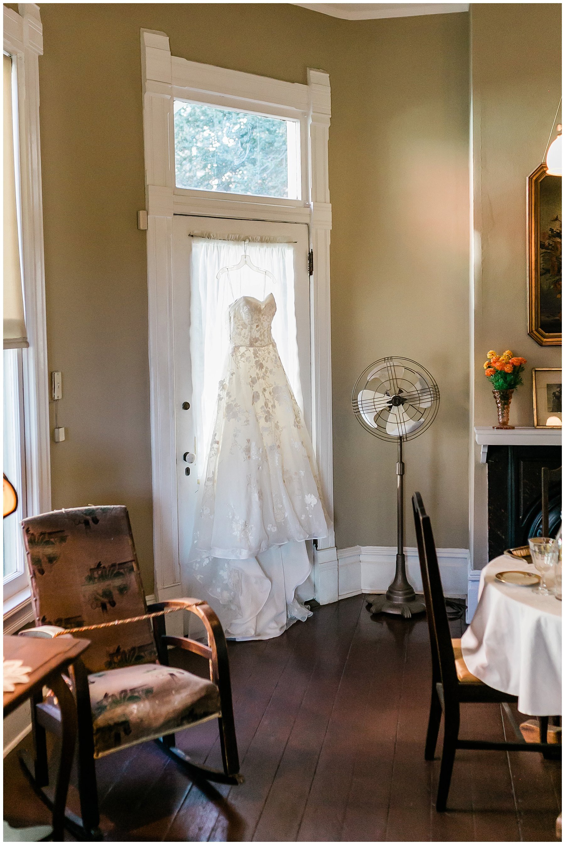  brides gown handing in the doorway 
