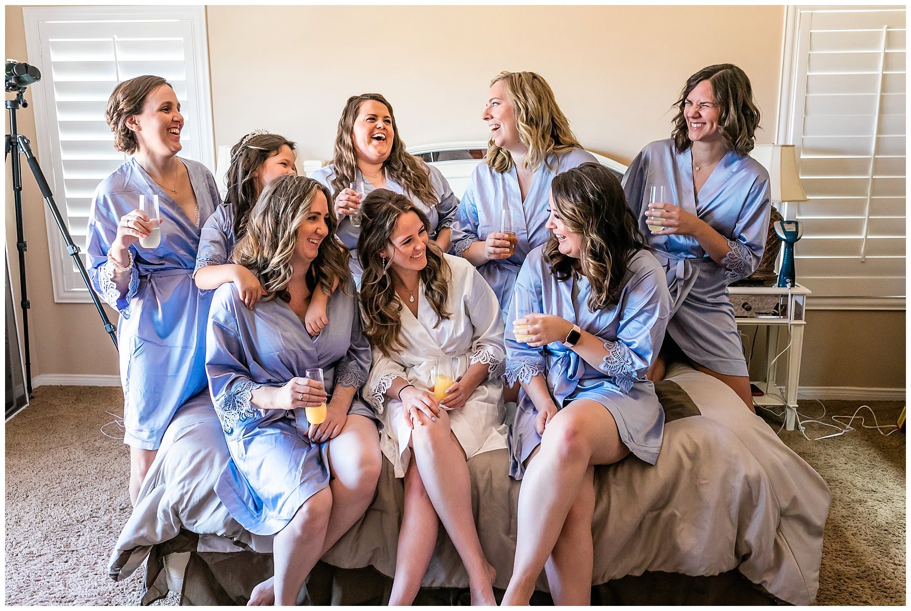  bride and bridesmaids in their robes with mimosas 