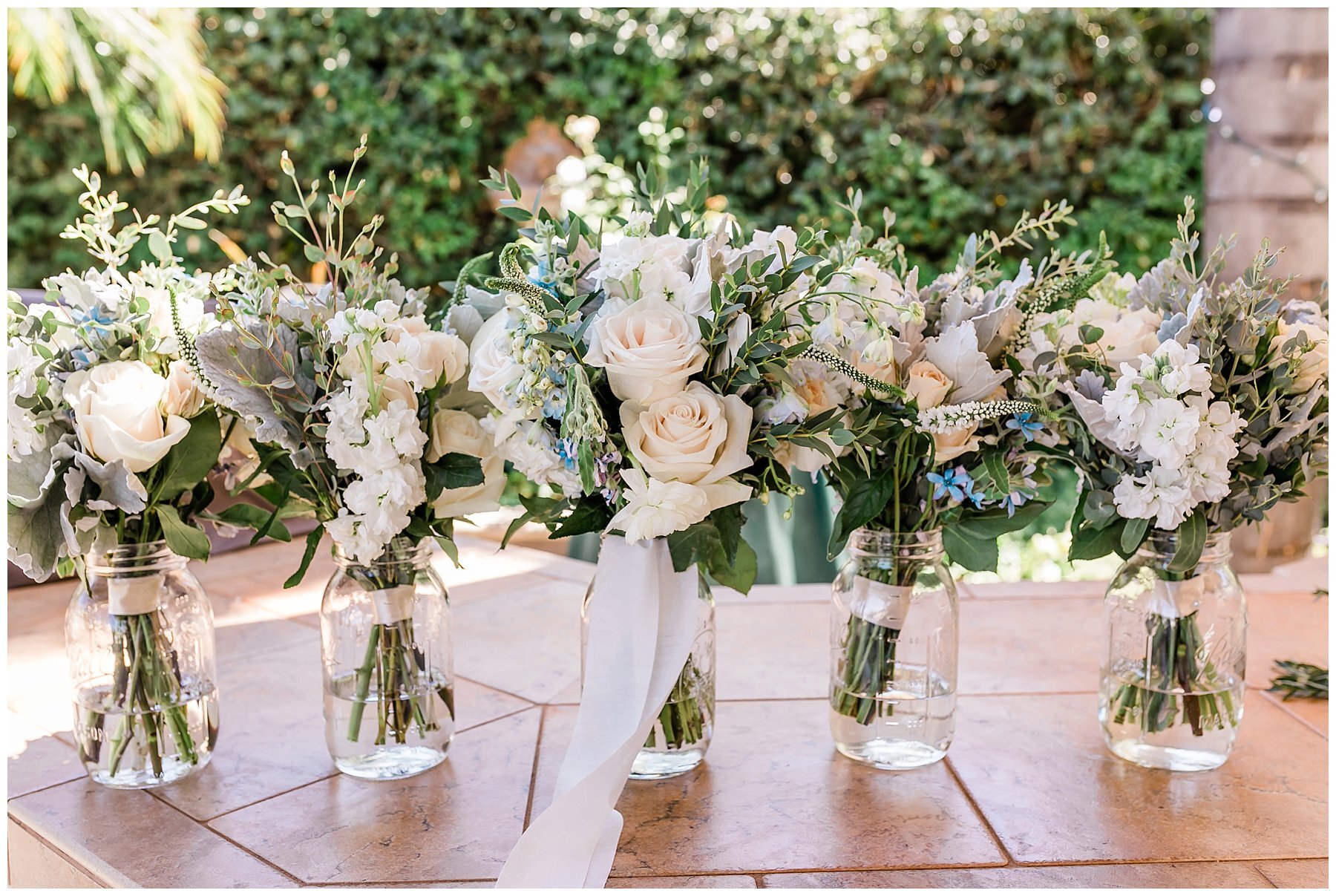  flowers in mason jars with water 