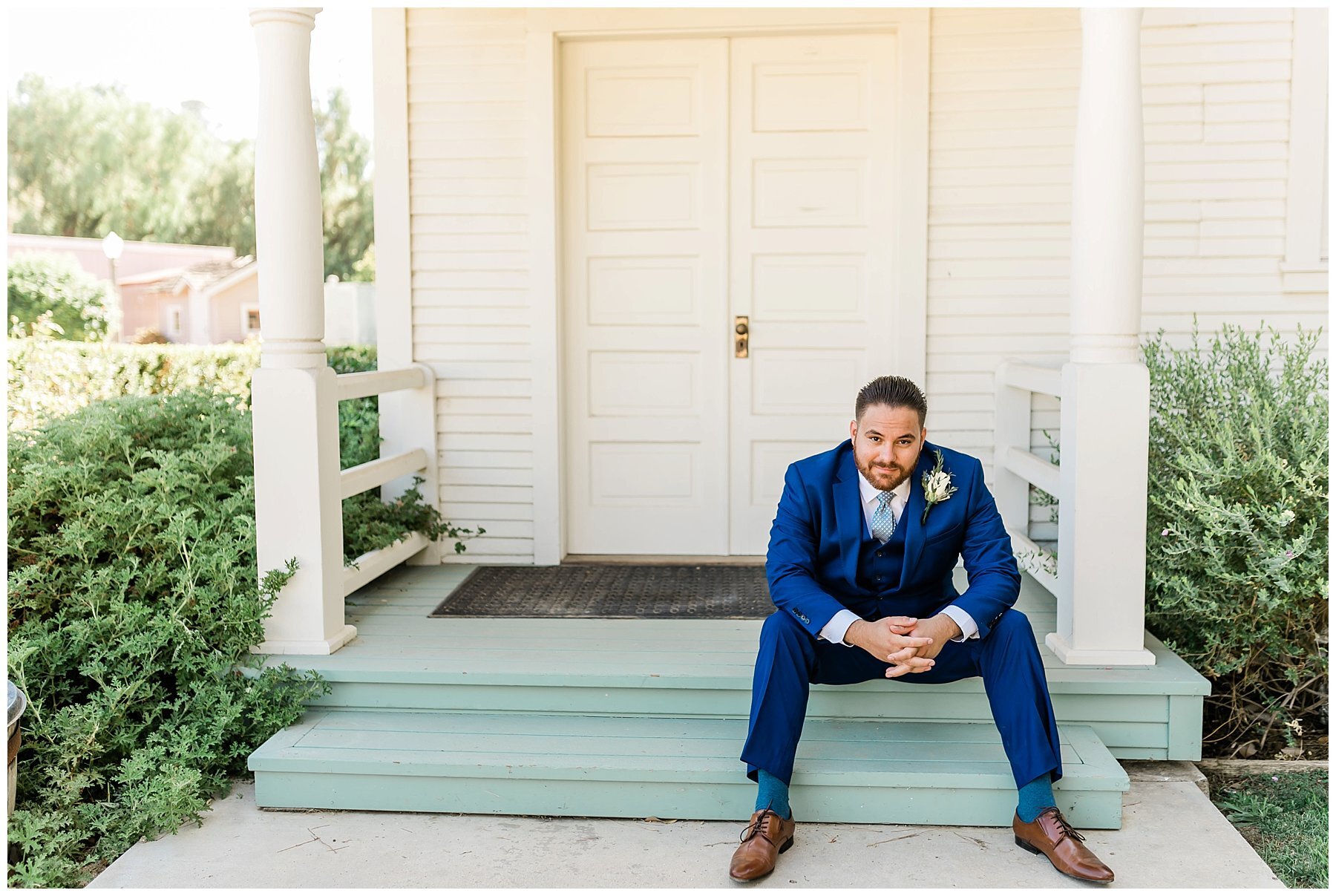  groom sitting on the steps of the house 