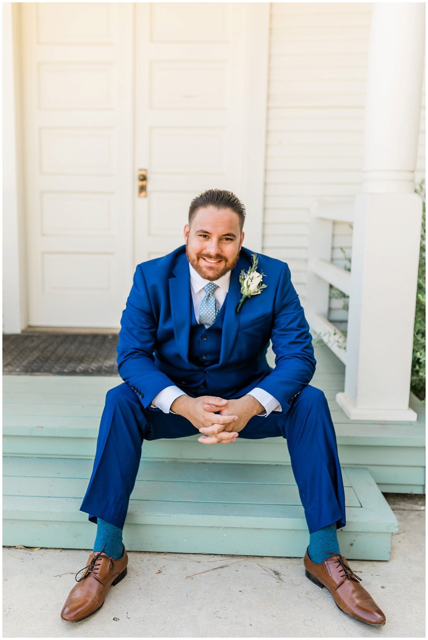  groom sitting on the steps of the house 