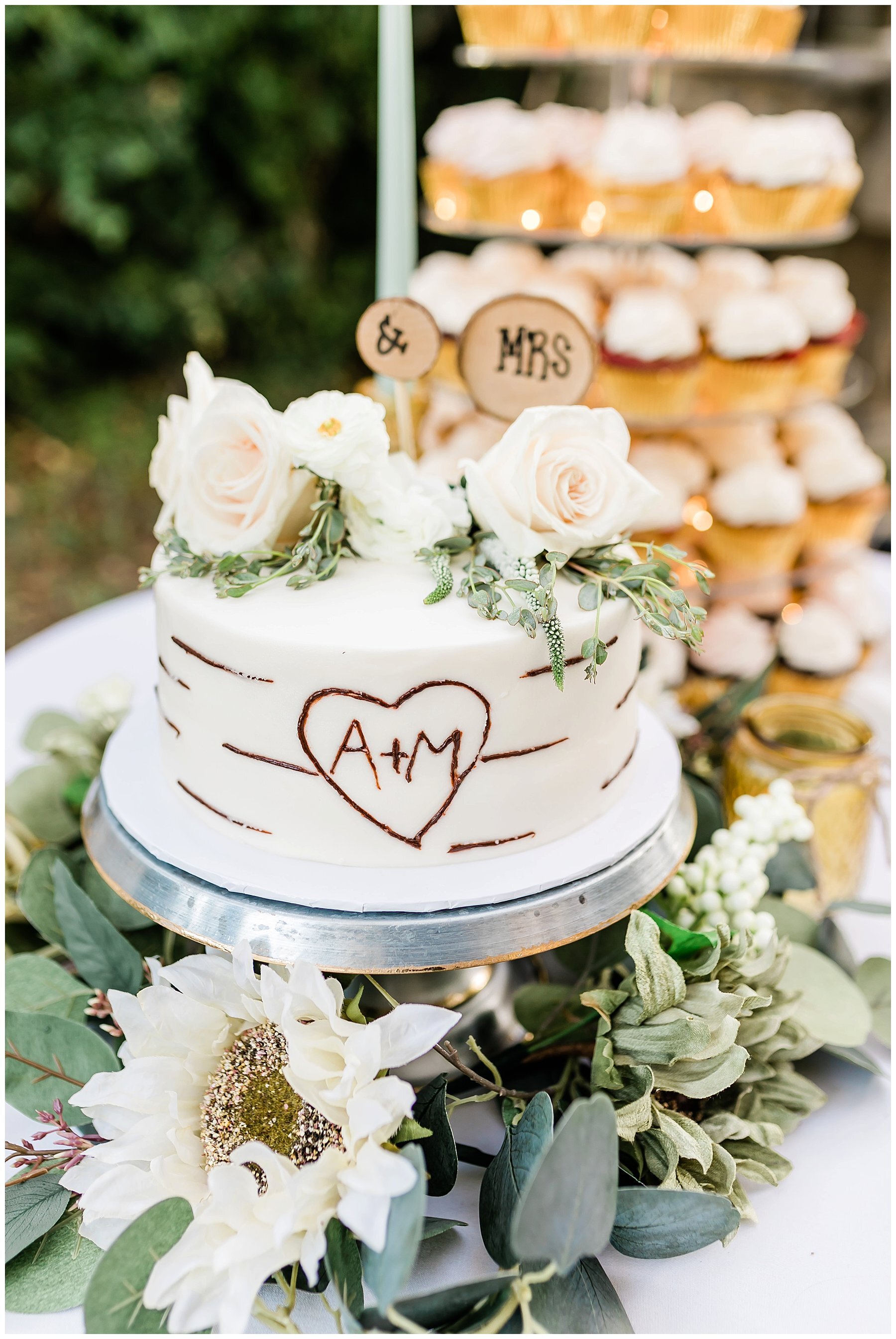  wedding cake and cupcakes at the dessert table 