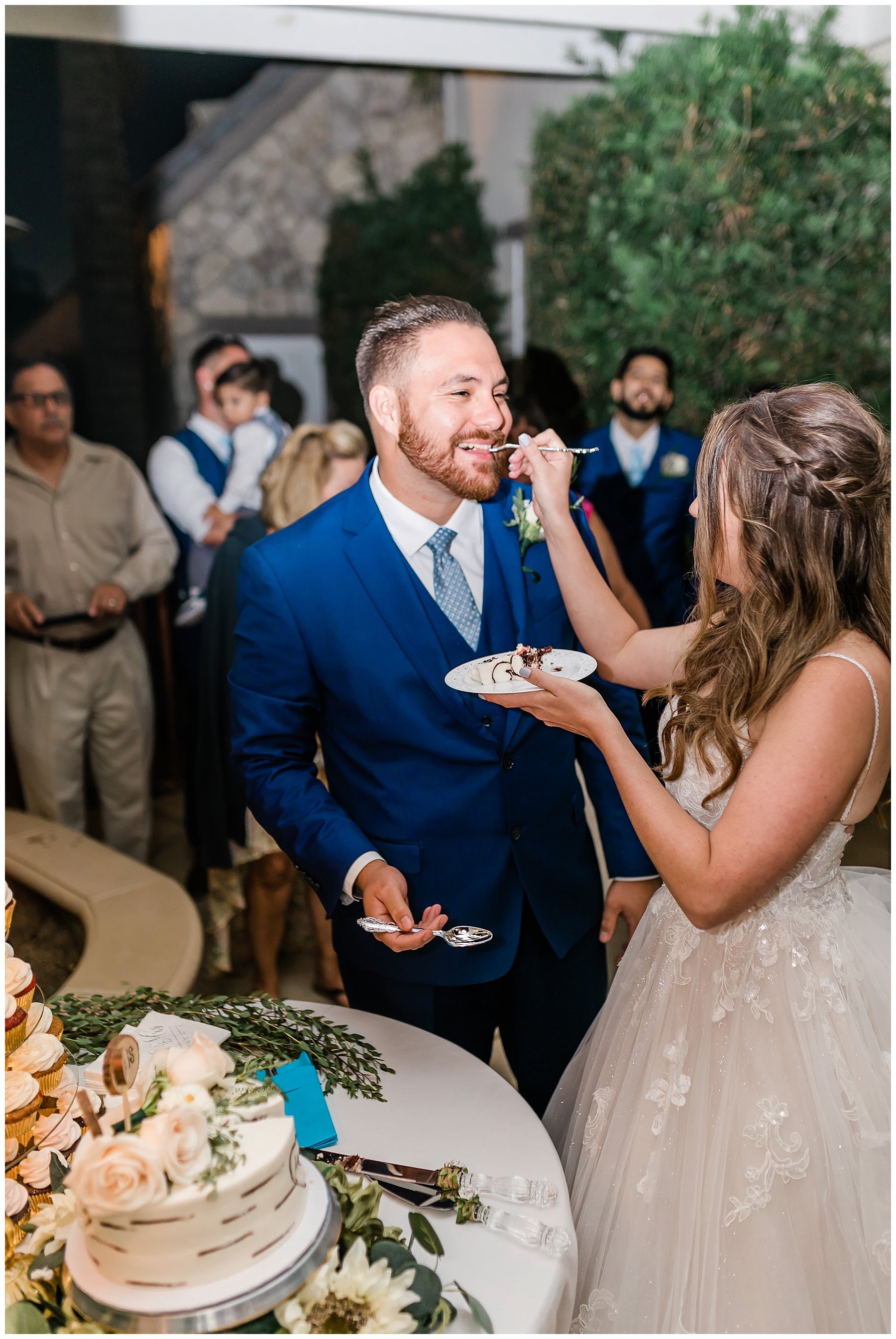  bride and groom eating cake 