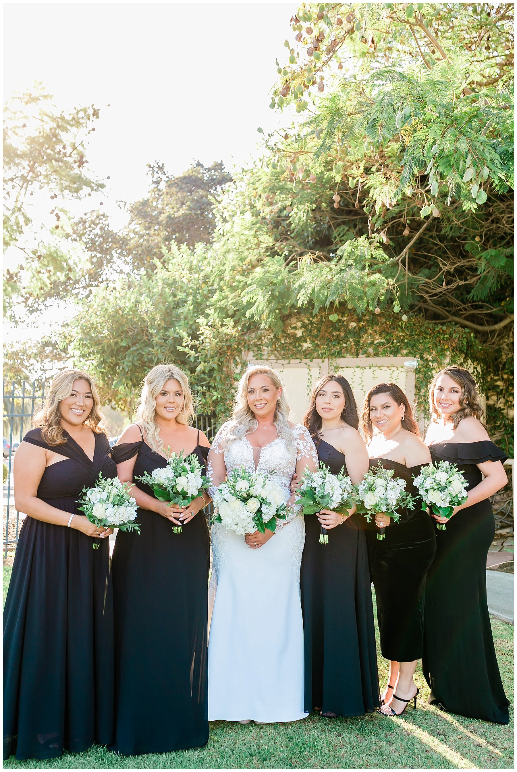  bridal party standing with their bouquets 