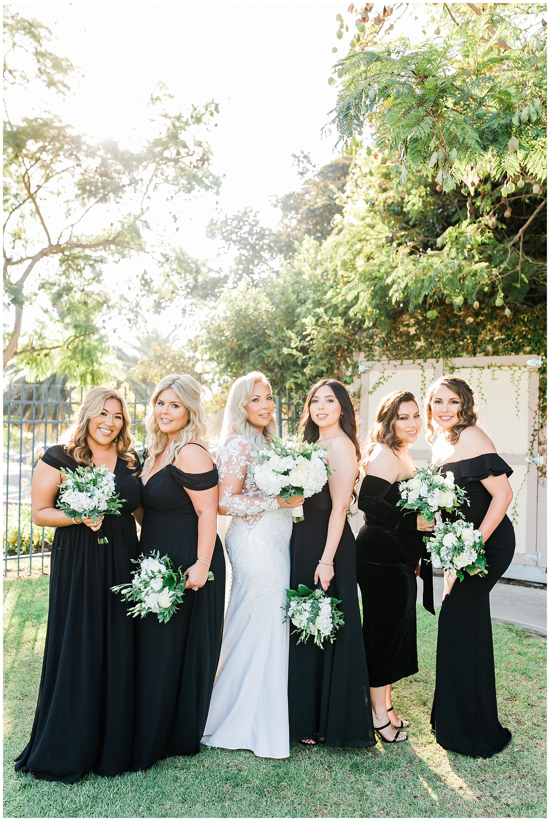  bridal party standing with their bouquets 