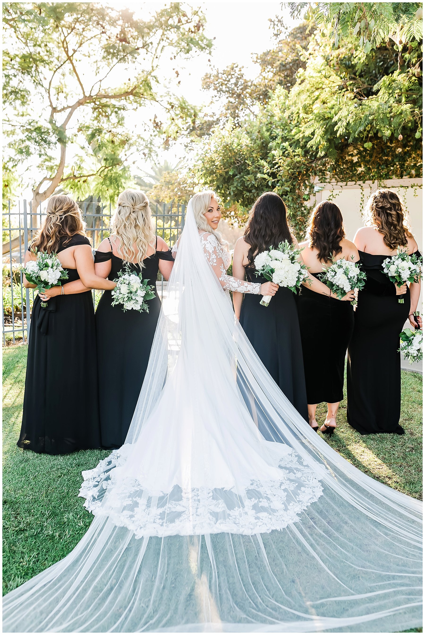  bridal party standing with their bouquets 