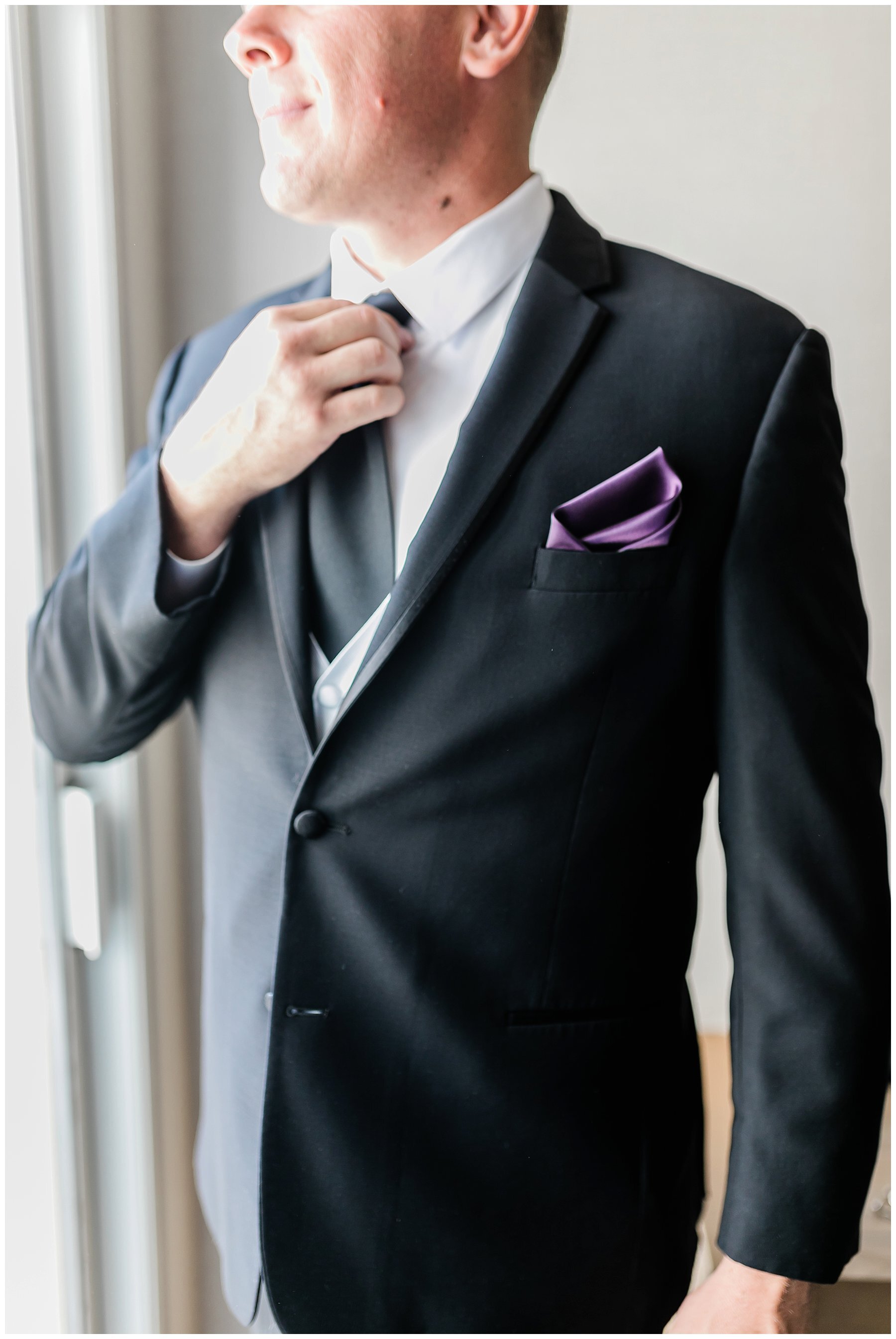  groom adjusting his tie 