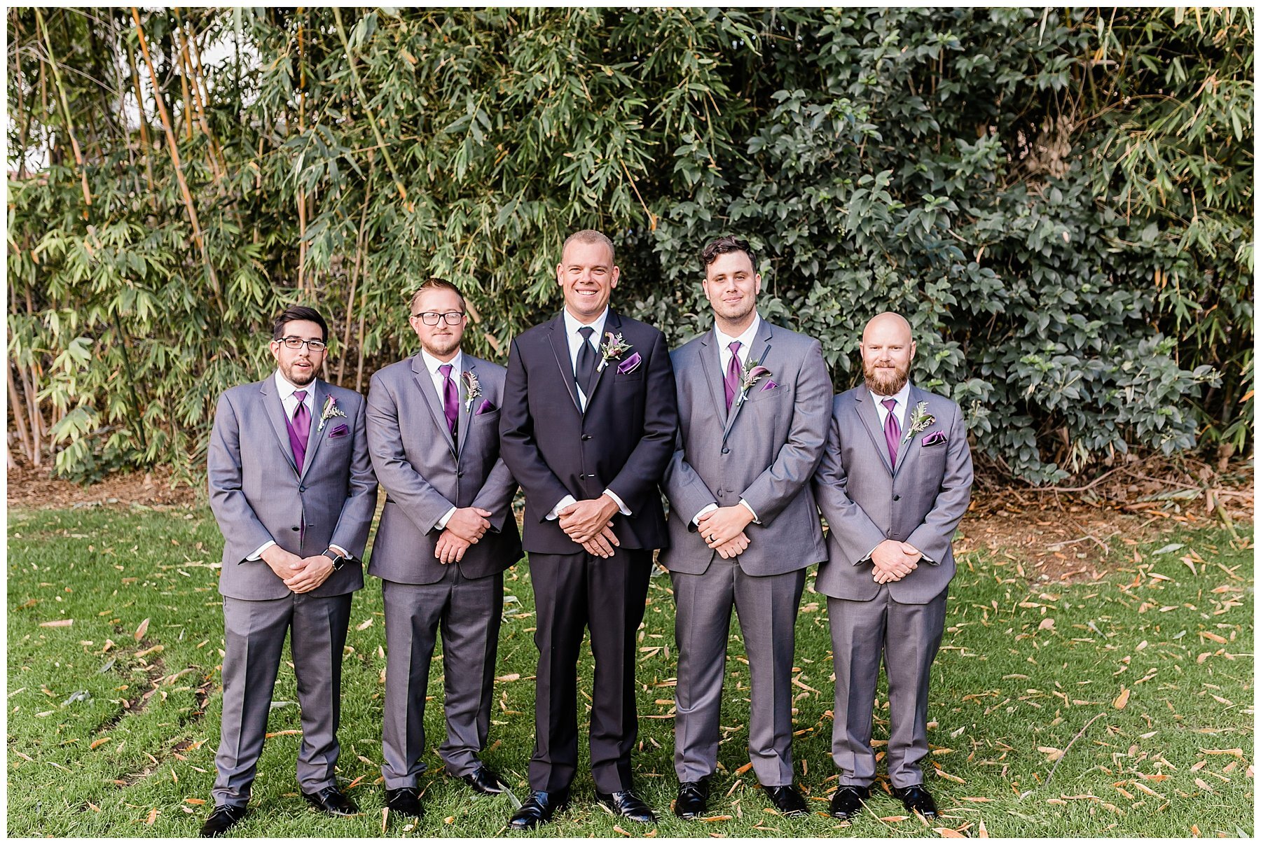  groom with groomsmen in front of the trees 