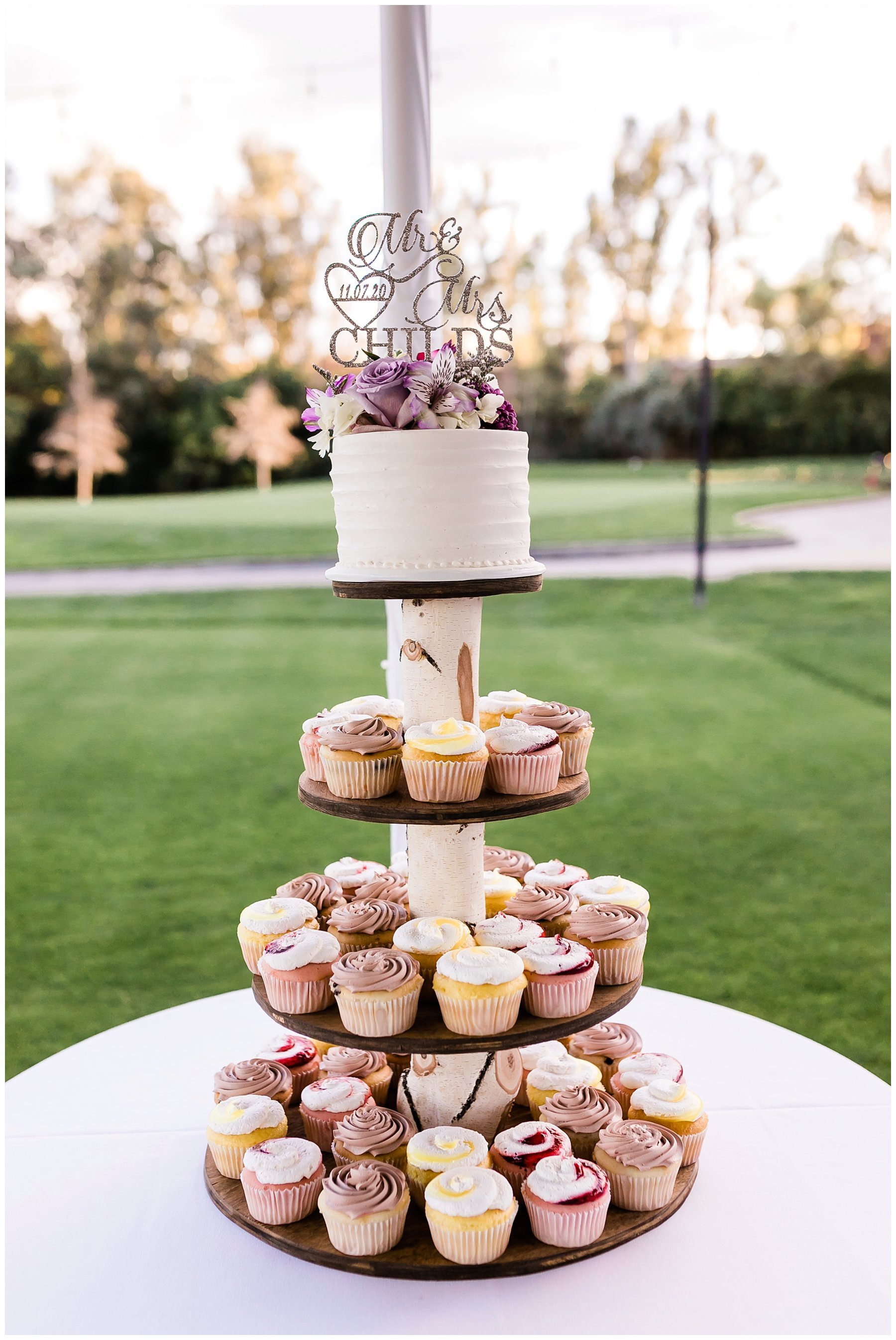  cupcake tower with small wedding cake on top 
