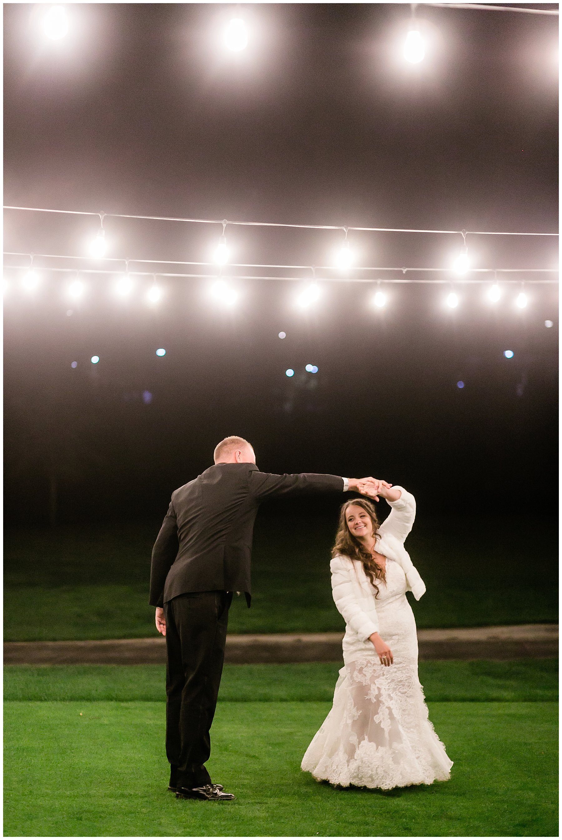  bride and groom dancing under lights 
