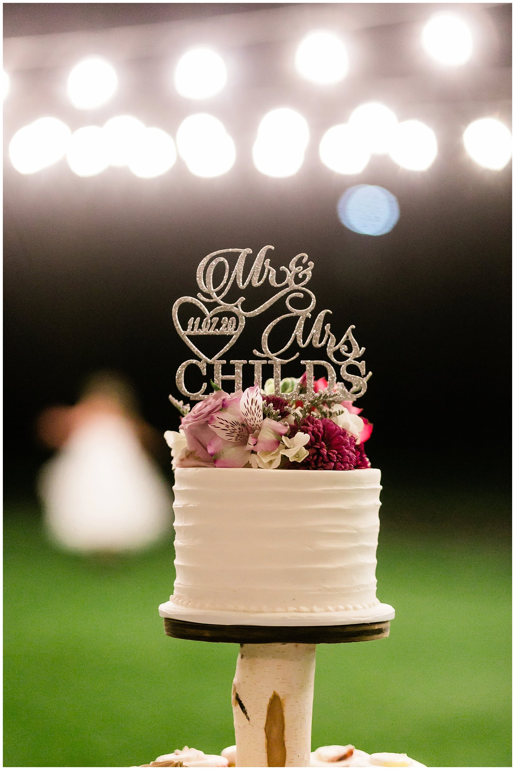  wedding cake with lights in the background 