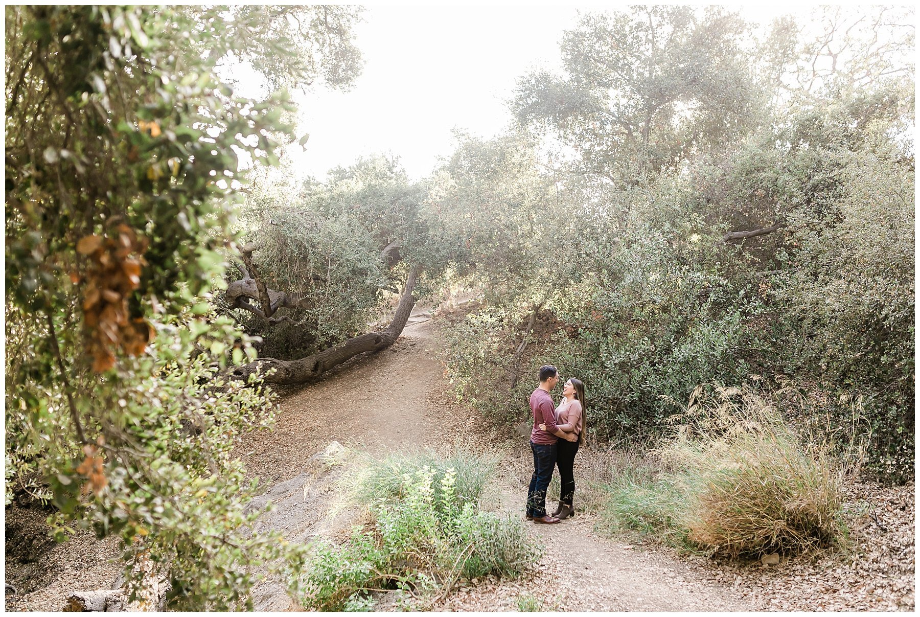  newly engaged couple embracing on the wildwood national park trail 