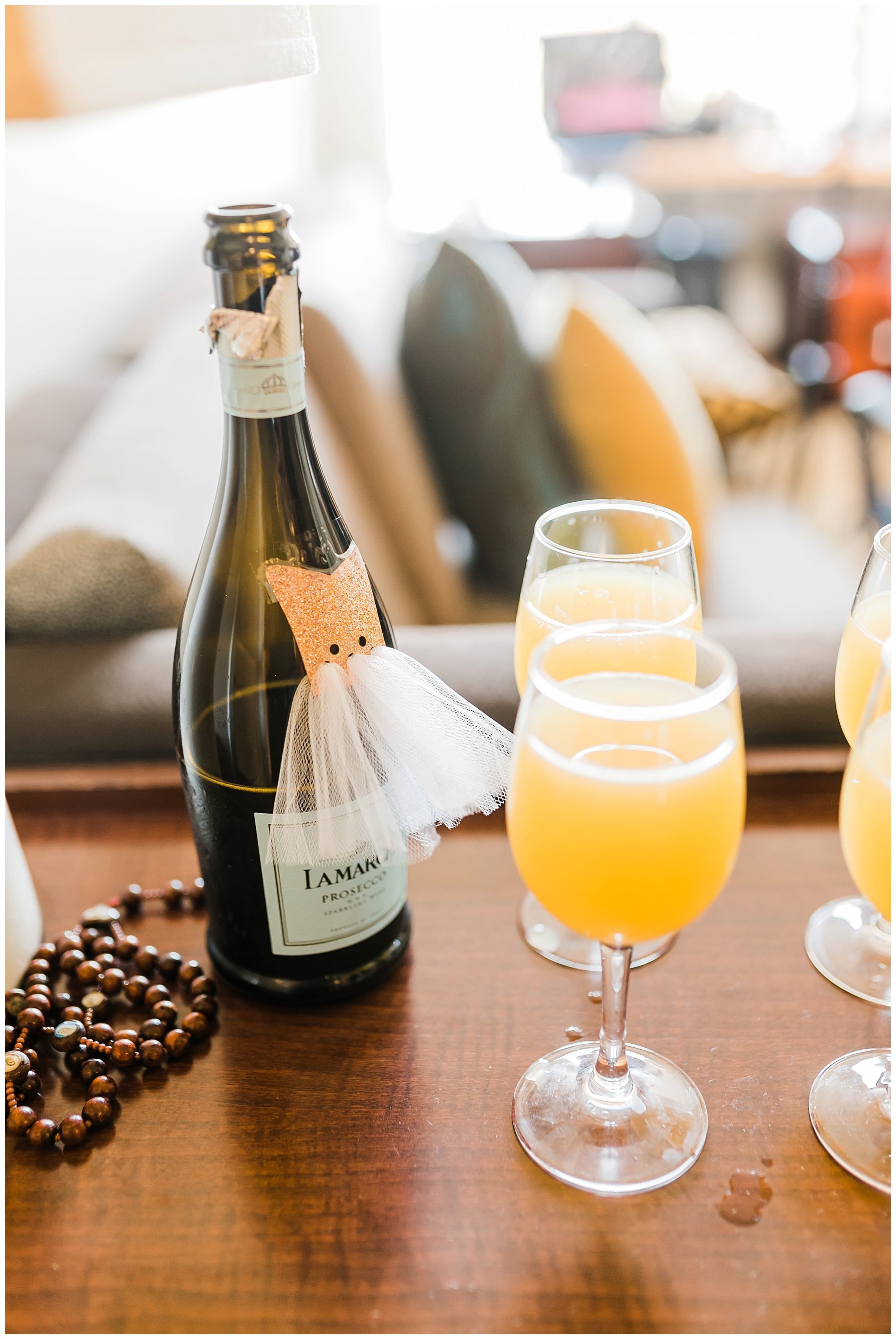  mimosas on the table with champagne bottle 