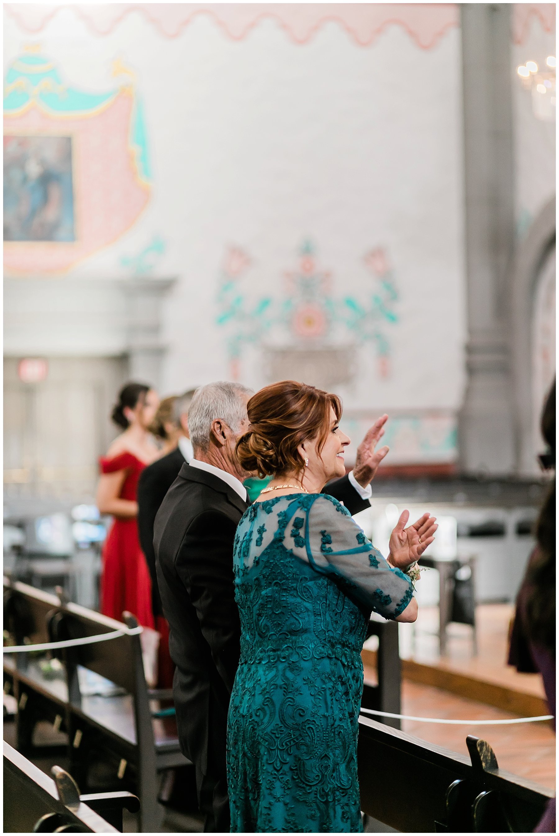  guests standing and applauding at the wedding ceremony 