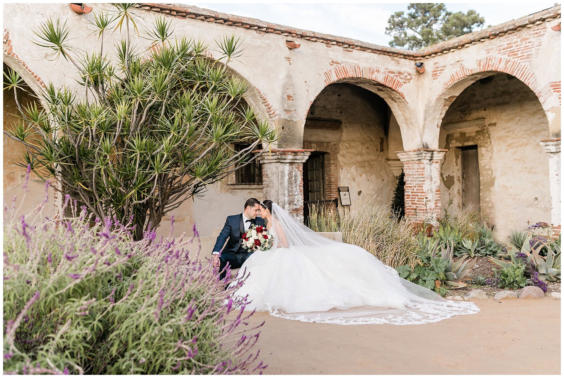  bride and groom in the courtyard with archways and greenery 