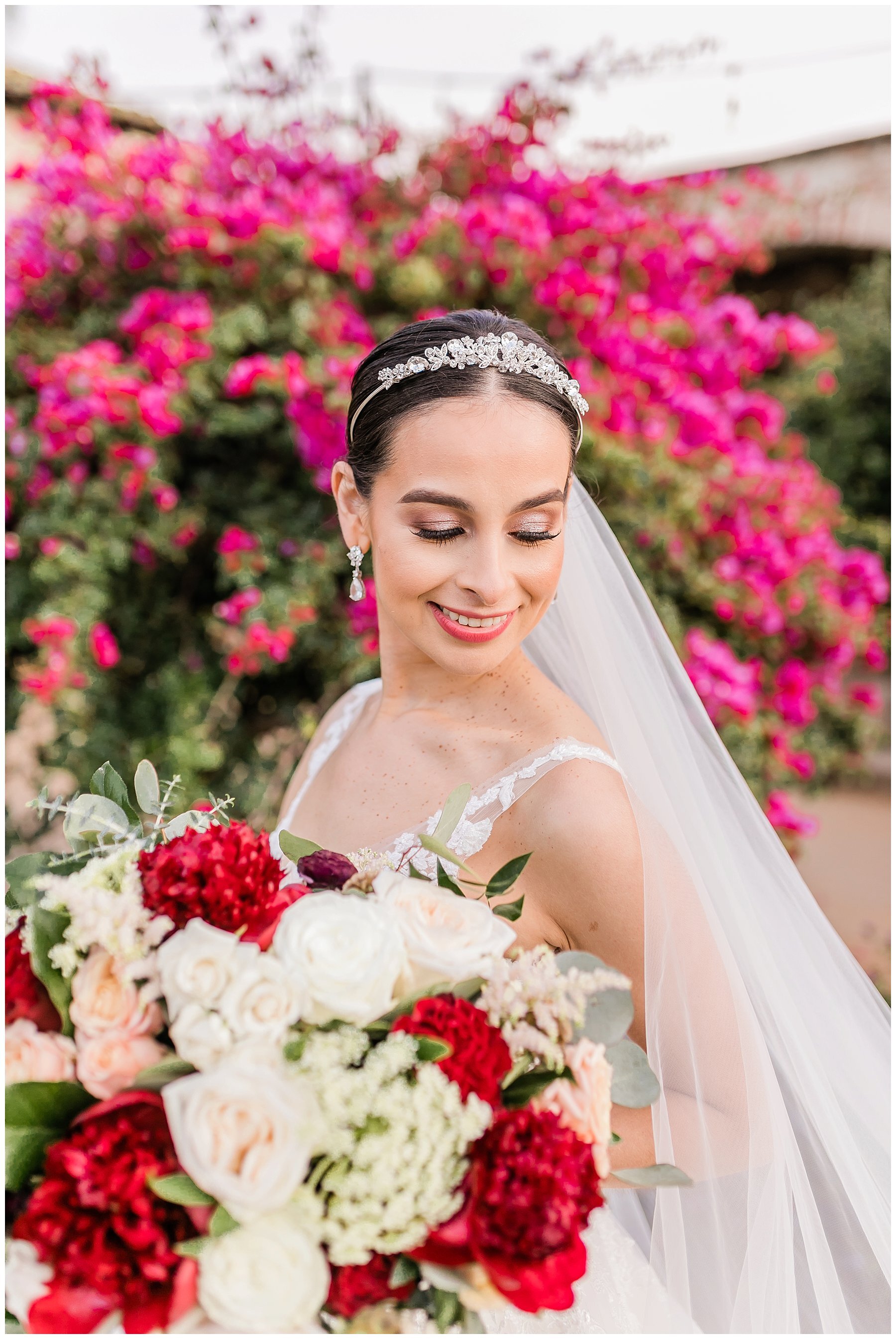  bride standing holding her bouquet and looking over her shoulder 