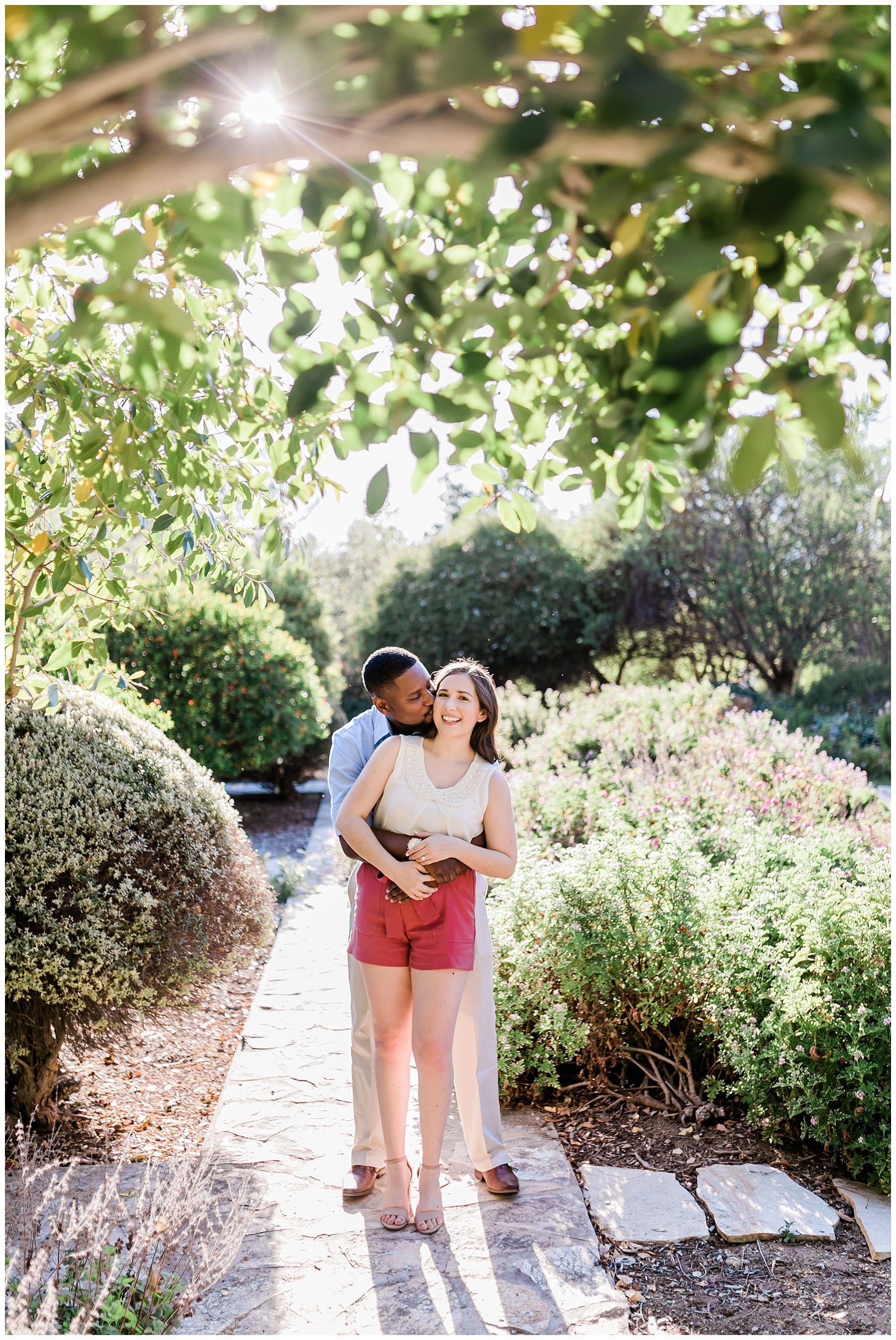  engaged couple standing in a garden 