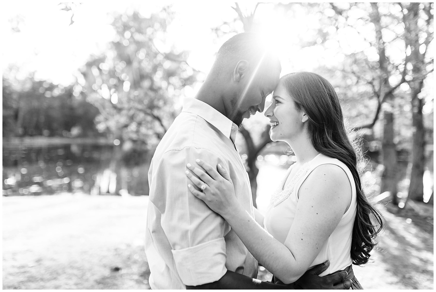  black and white photo of engaged couple touching foreheads 