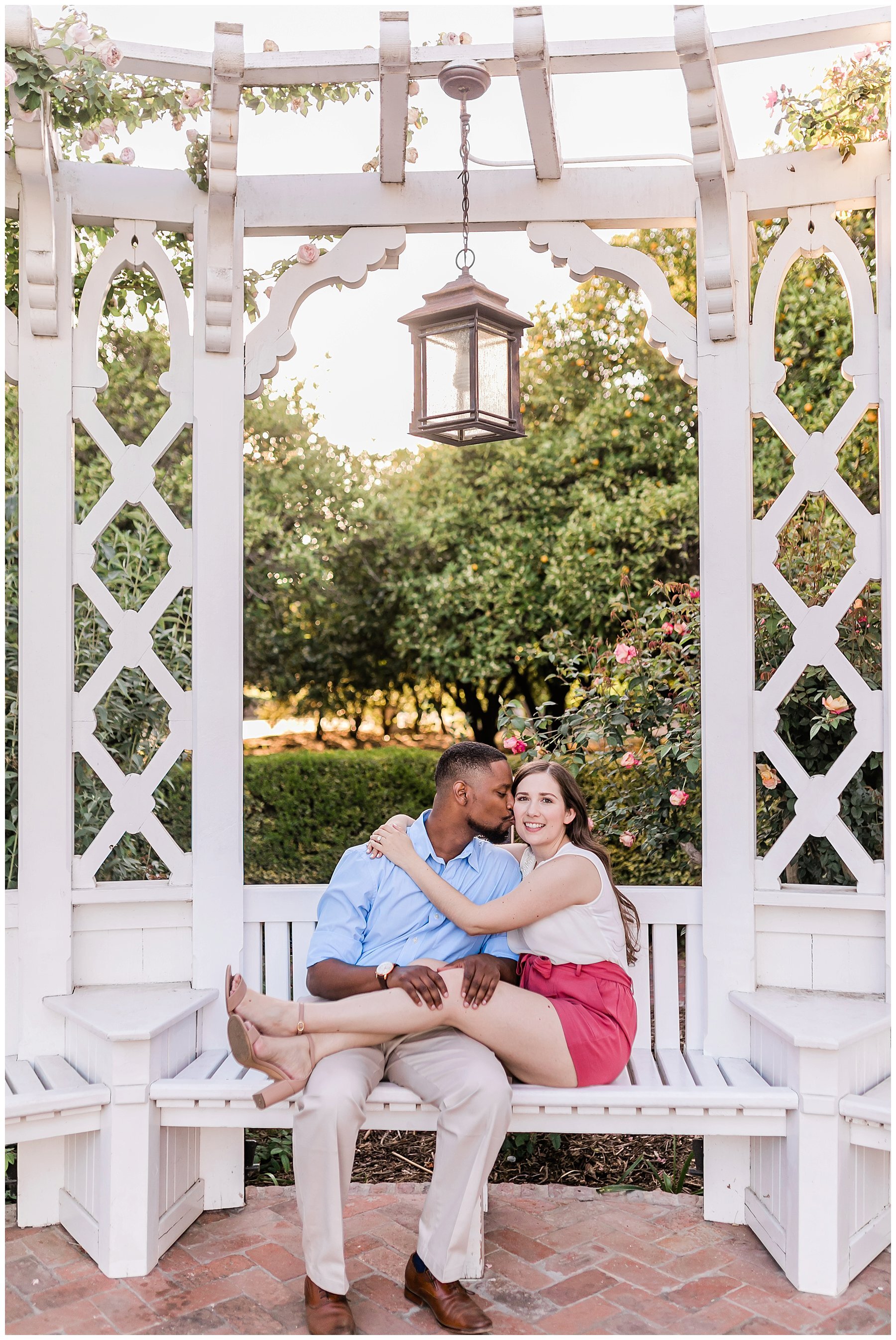  engaged couple sitting under an archway 