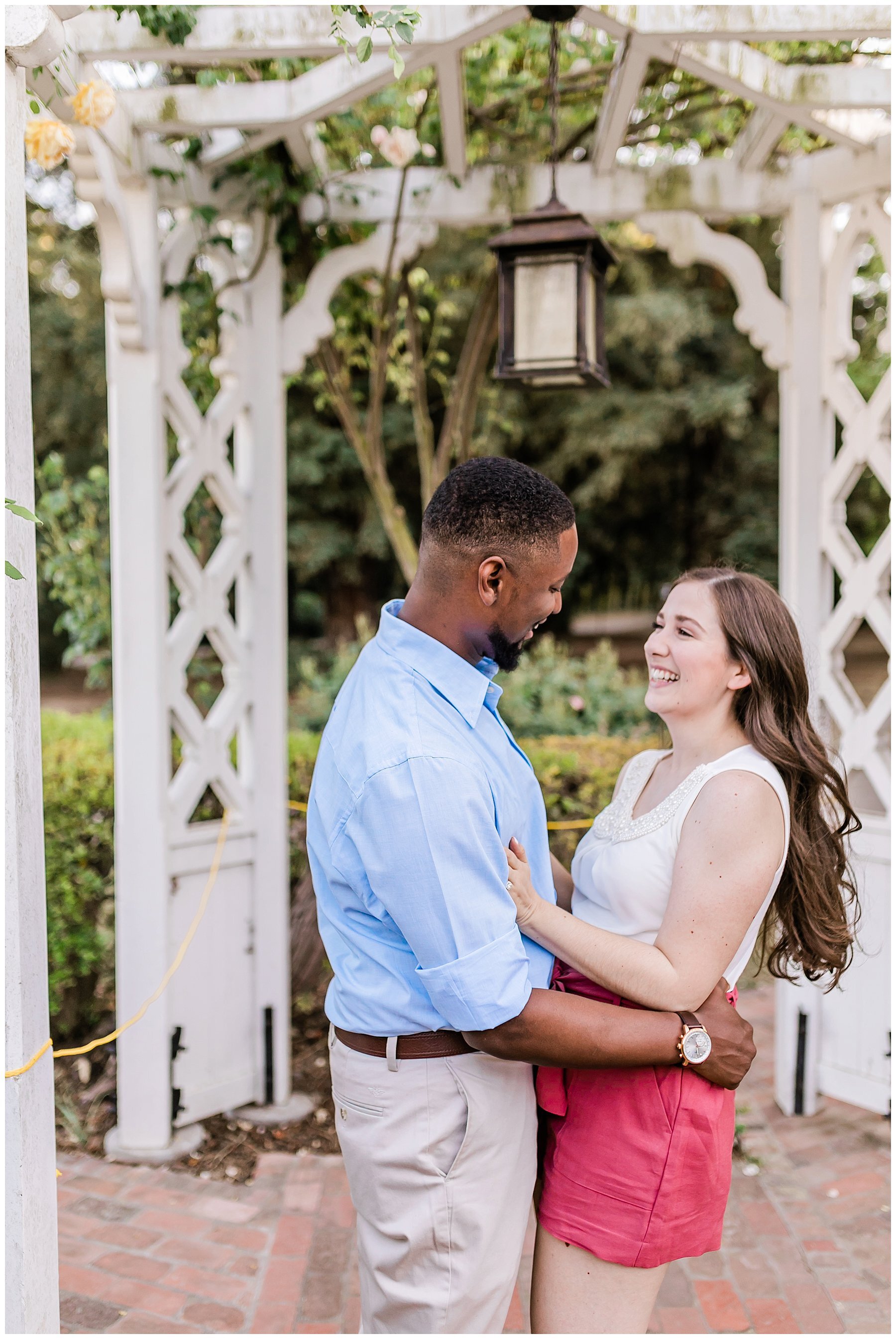  engaged couple in front of an archway 