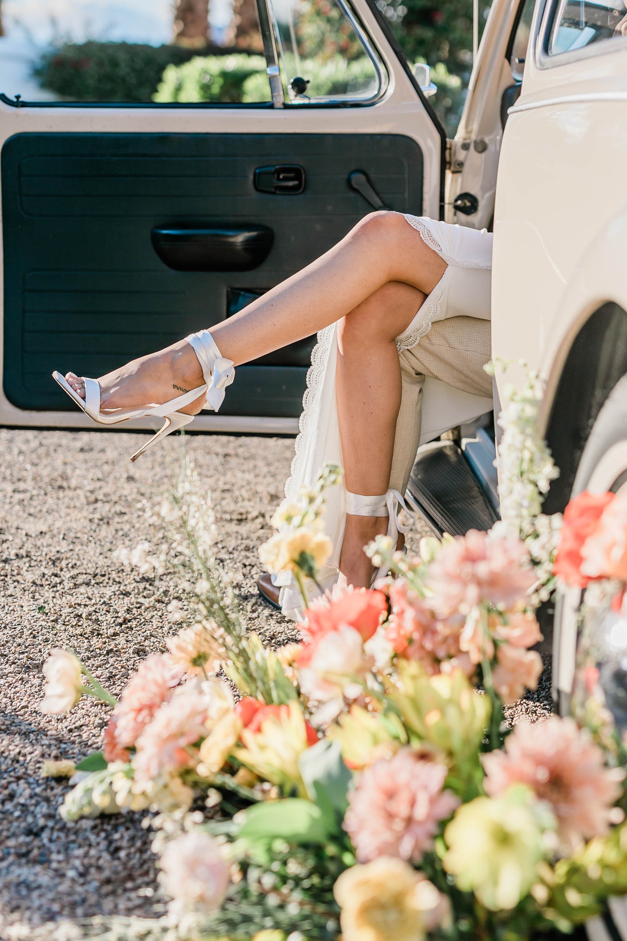 Retro bride and groom portraits with vintage vw bug at Palm Springs wedding location Bougainvillea Estate.