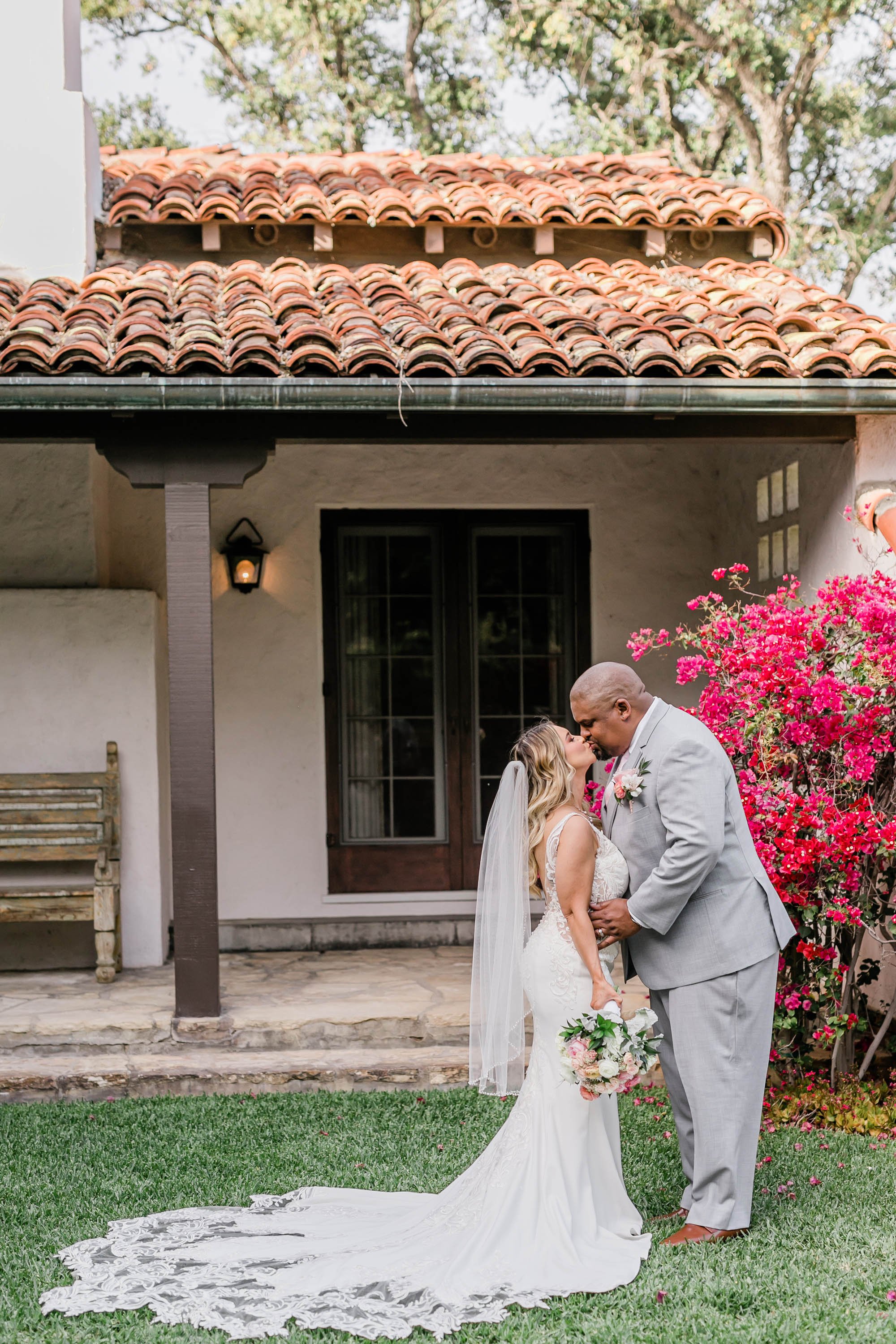 Bride and groom portrait with bougainvillea flowers at Spanish style ranch house at Quail Ranch events weddin
