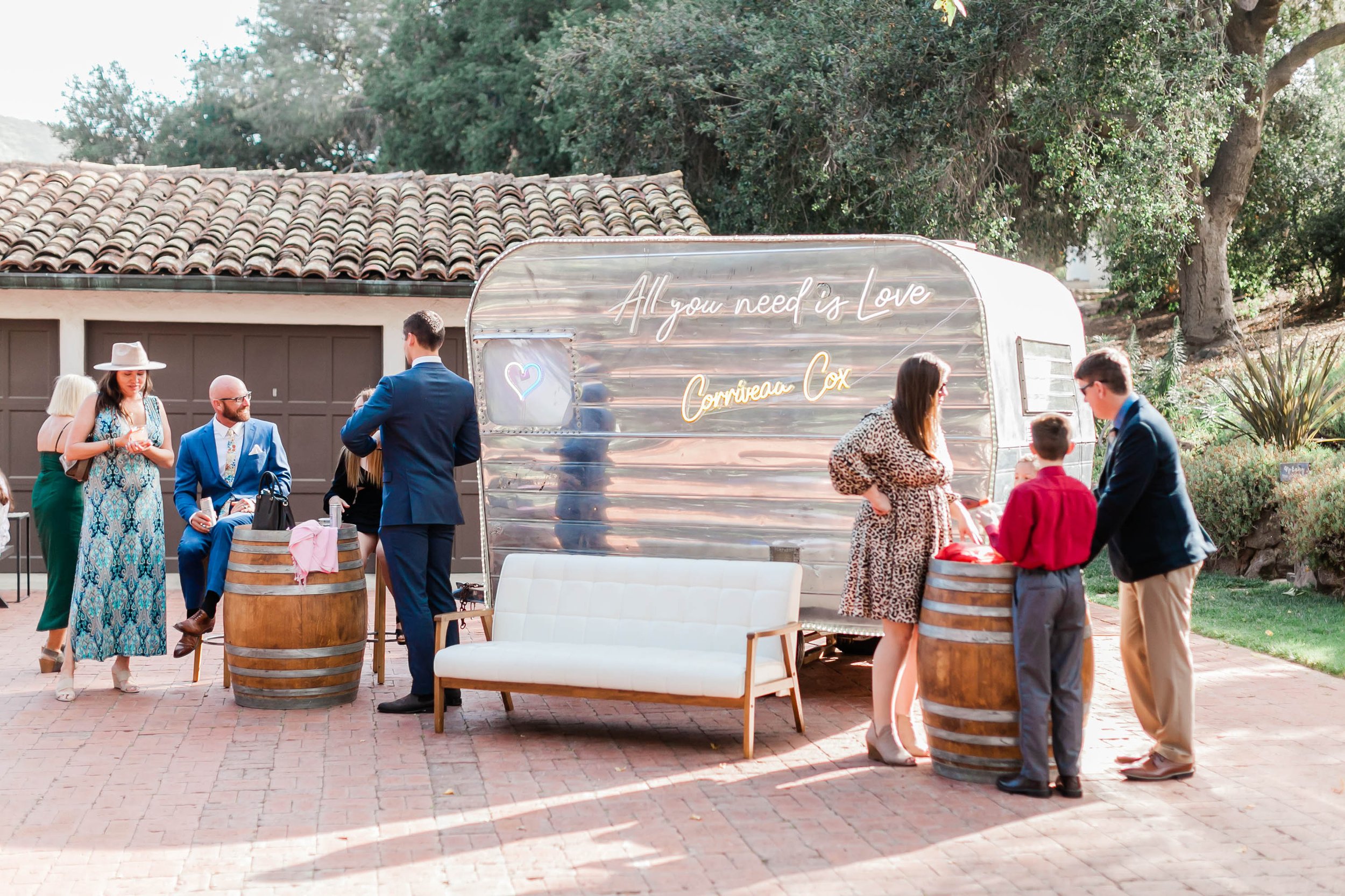 outdoor cocktail hour under oak trees at Spanish style ranch house at Quail Ranch events weddin