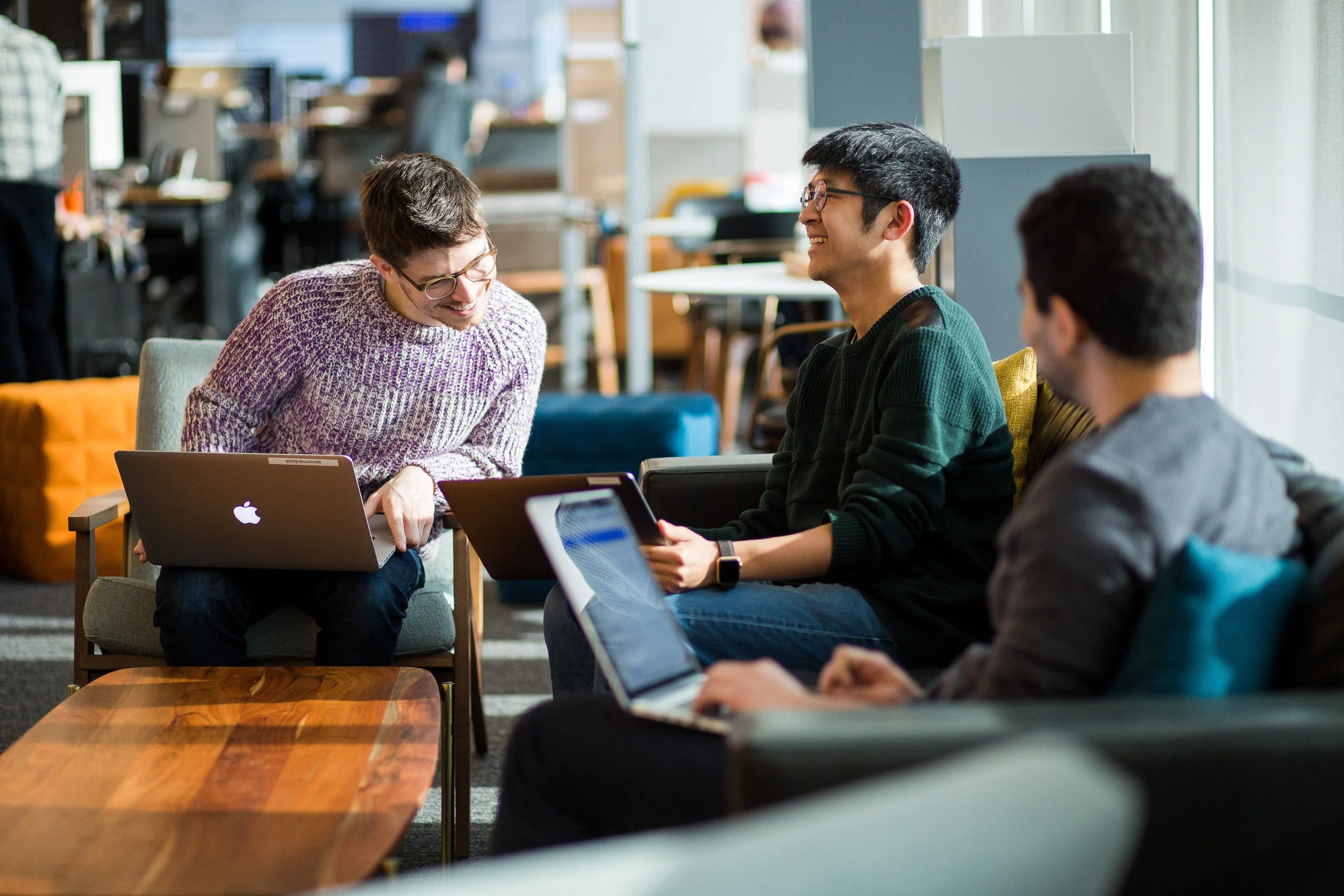 Corporate lifestyle photography of employees working together in a bright and sunny NYC office