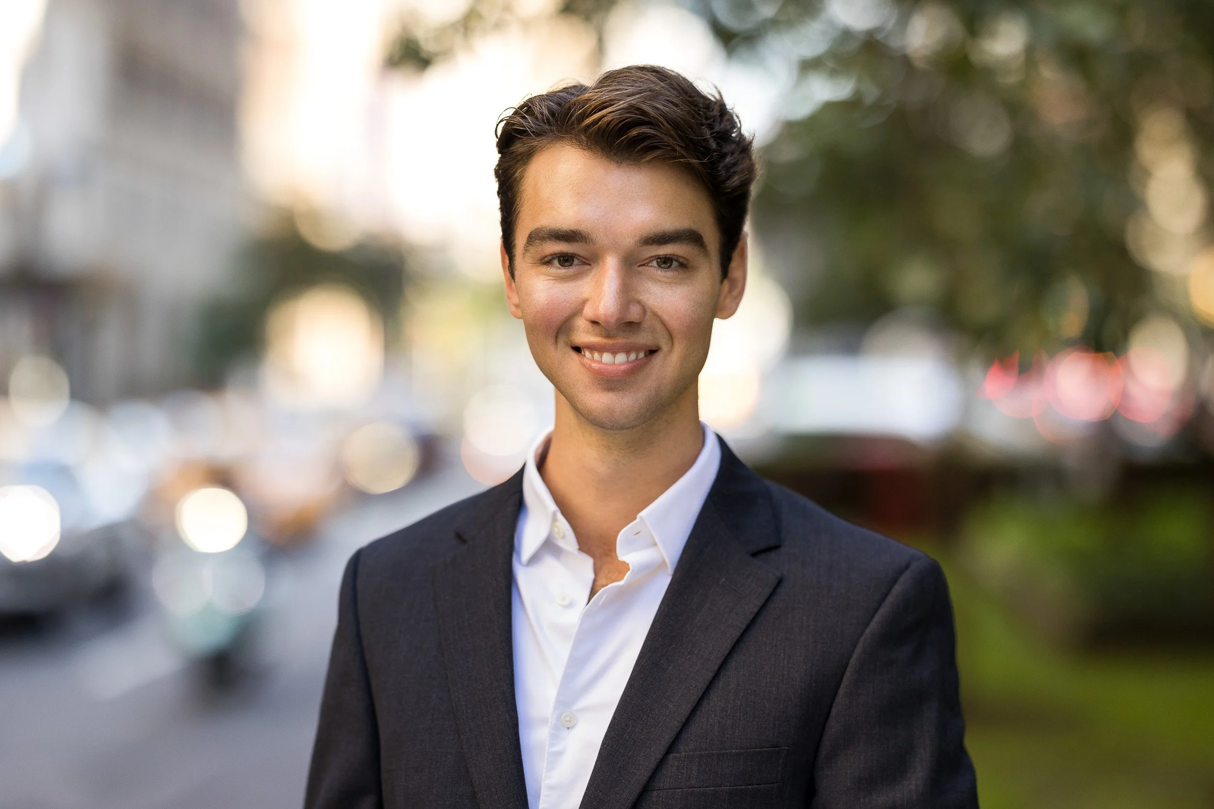 Professional headshot of a man in his 30s taken outdoors with natural light in New York City