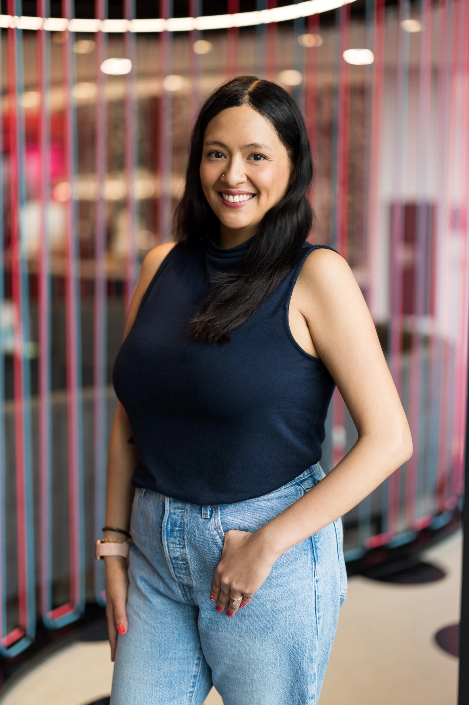 Creative corporate portrait of young female employee posing in a colorful office in NYC