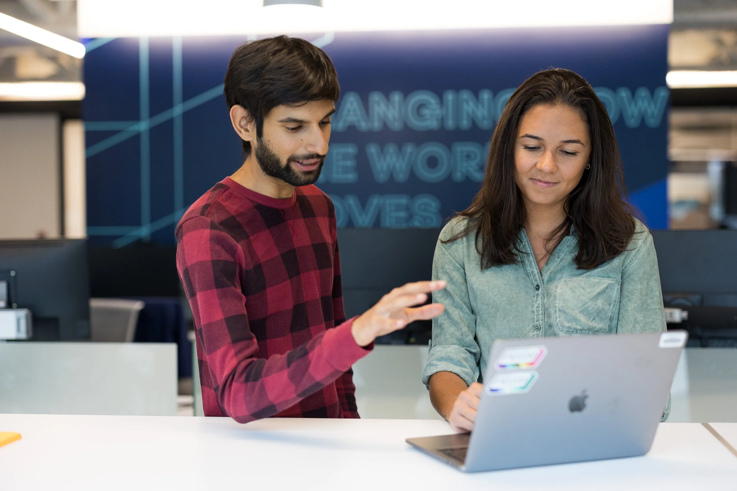 Corporate lifestyle photography of a man and a woman coworking on a laptop. 