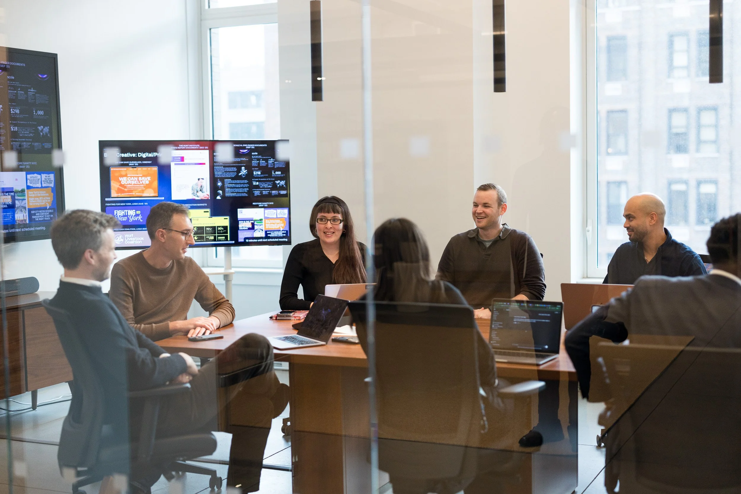 A group of employees having an informal meeting in a conference room. 