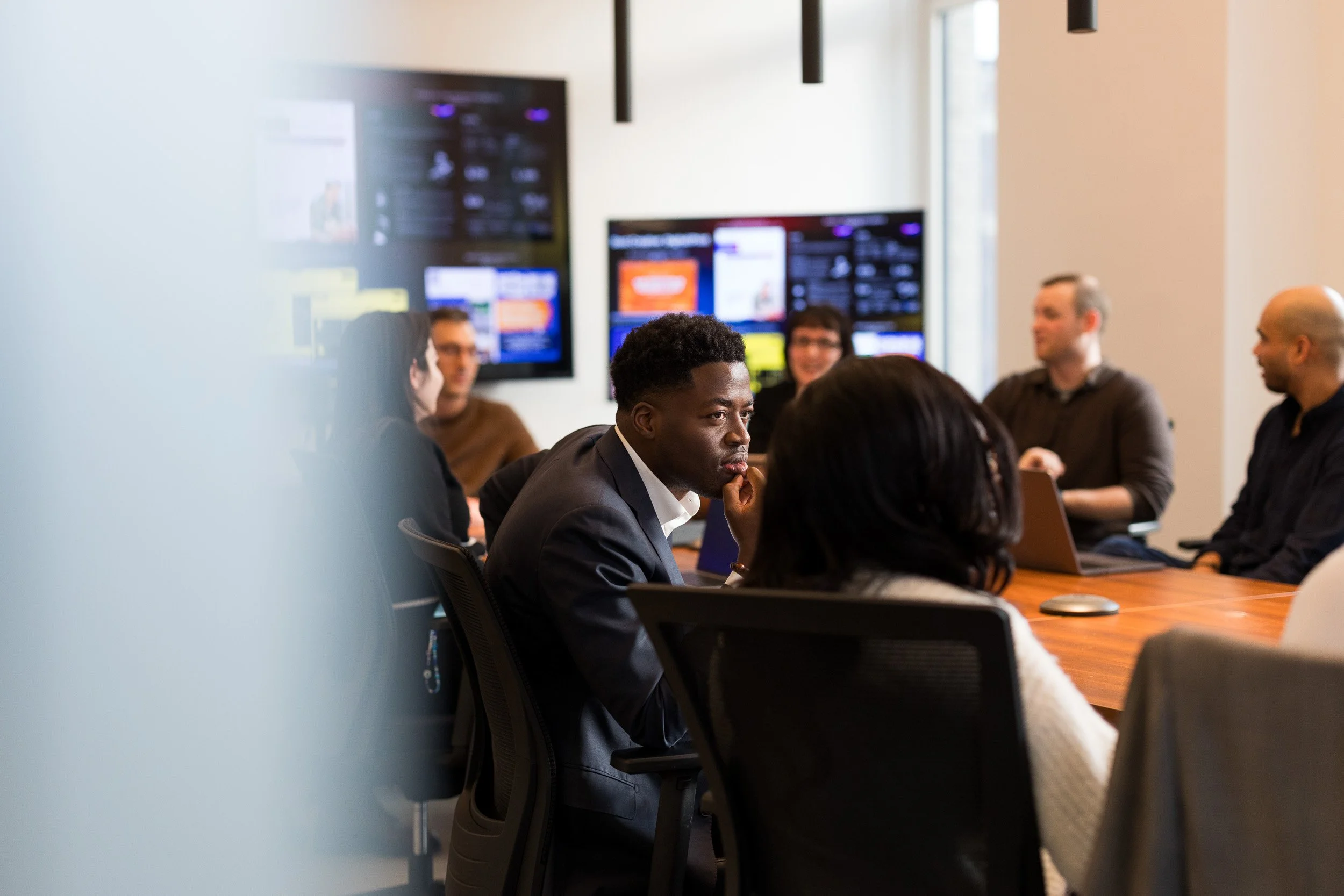 Corporate lifestyle photography showing a coworking scene of employees collaborating in a conference room of their NYC office