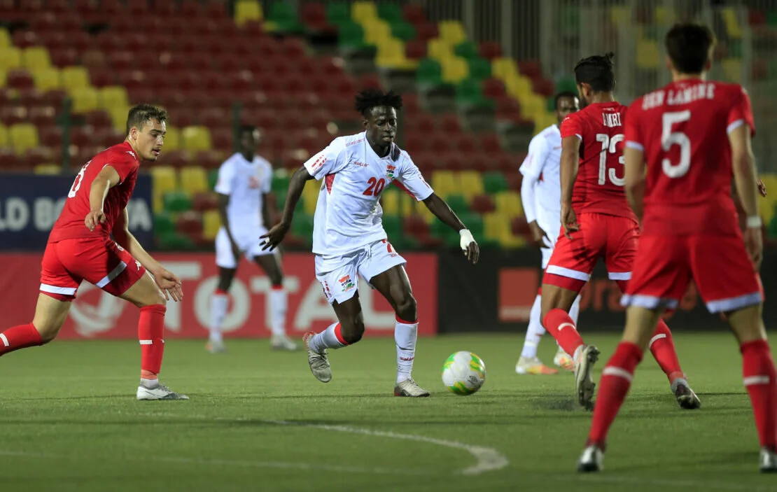 Impressive Gambian winger Wally Fofana surrounded by Tunisian players
