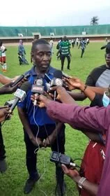 Foday Bah with reporters after his team lost at home to Burkina Faso