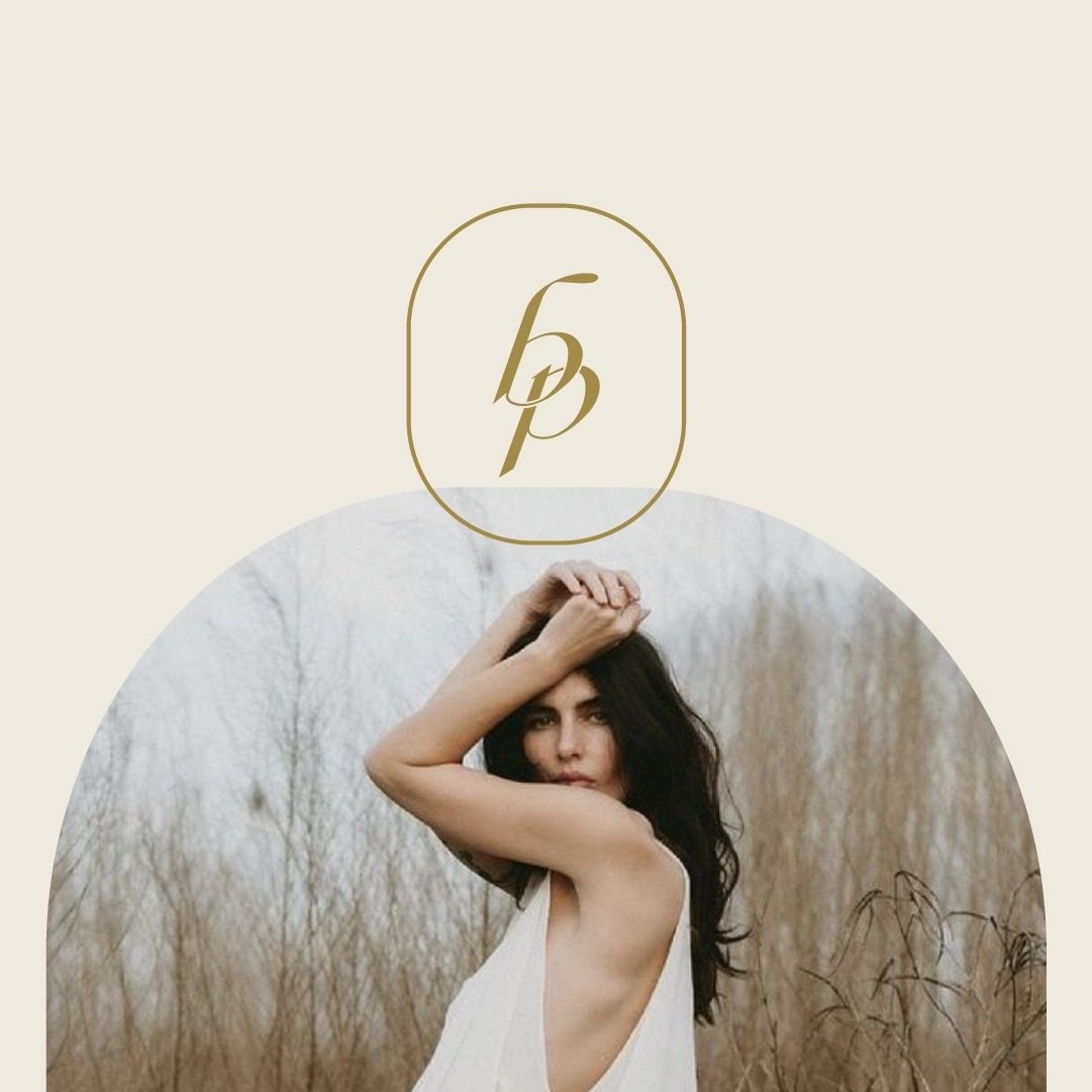 Brand mark with letters bp in rounded rectangle shape overlaying image taken by Briana Purser Photography of woman in field in white dress with arms resting on head