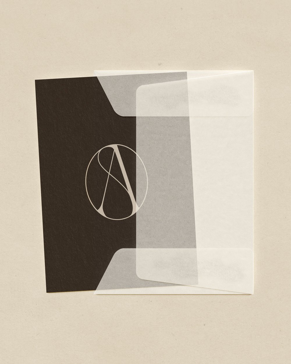 Envelope with chocolate brown card with an A monogram printed on it.