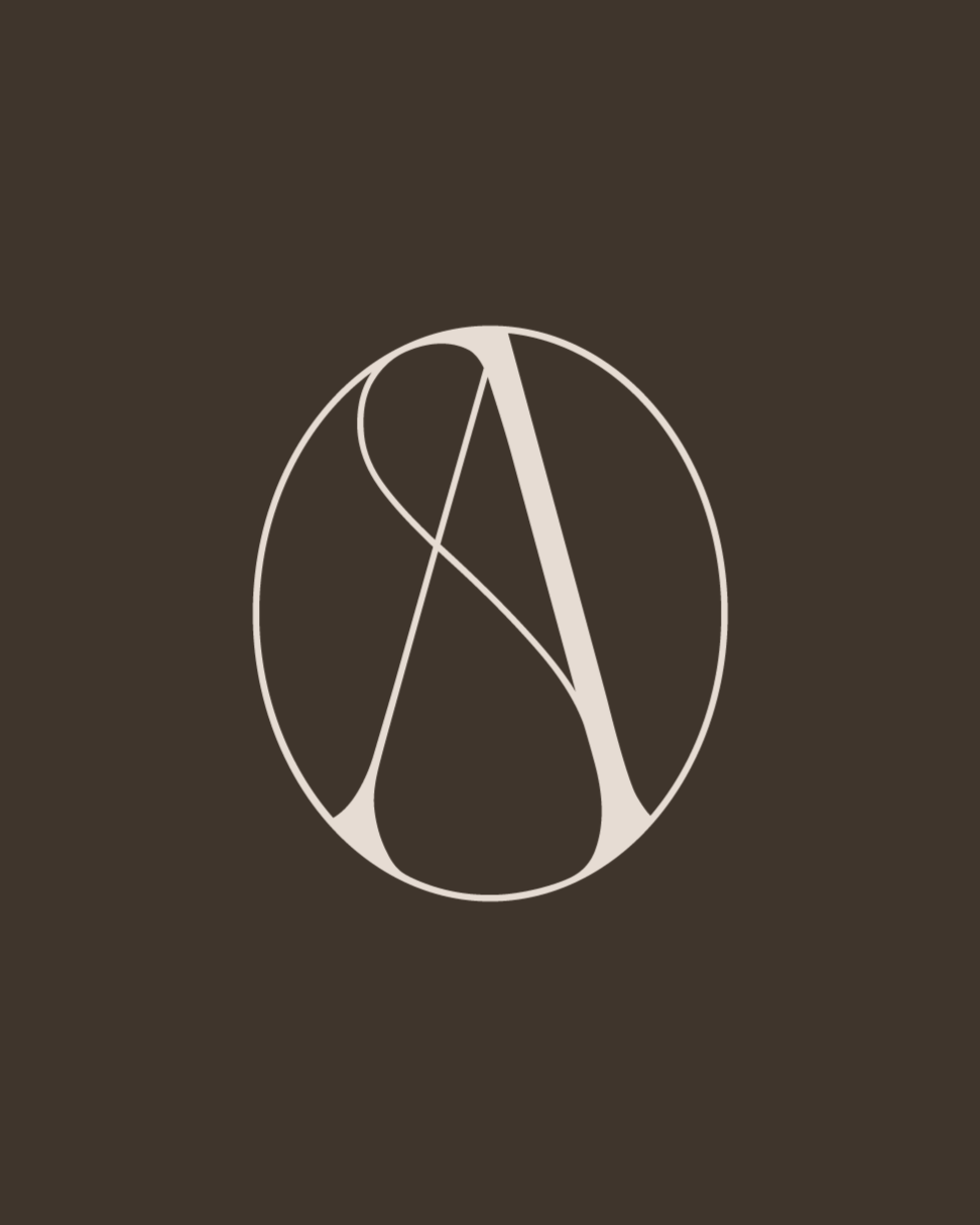 Cream coloured monogram logo of the letter A on a chocolate brown background