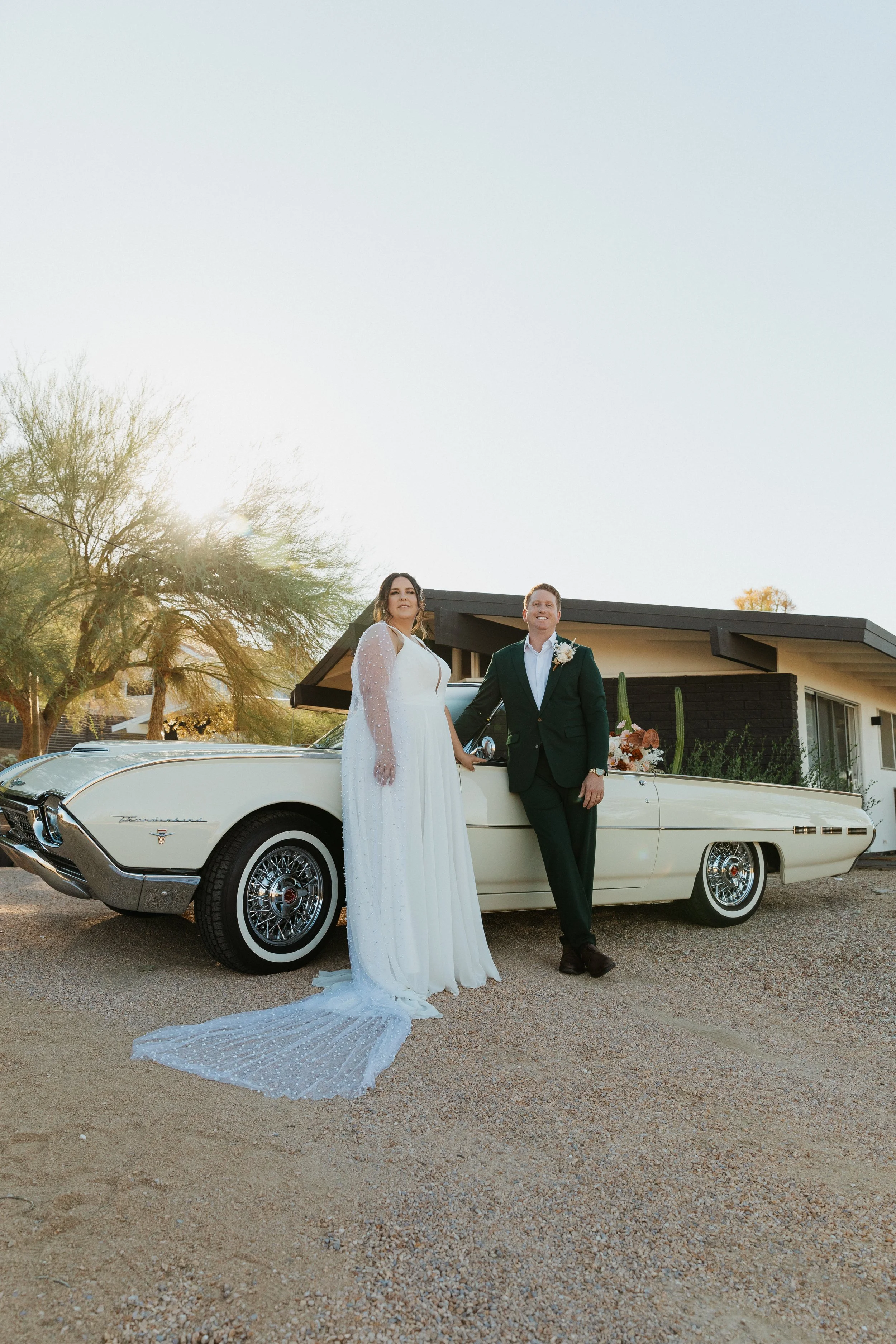Eloping bride in front of car photo shoot in Joshua Tree AirBnb makeup and hair photo shoot makeup artist