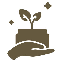 A hand holding a small plant growing in a pot with two stars or sparkles around it.