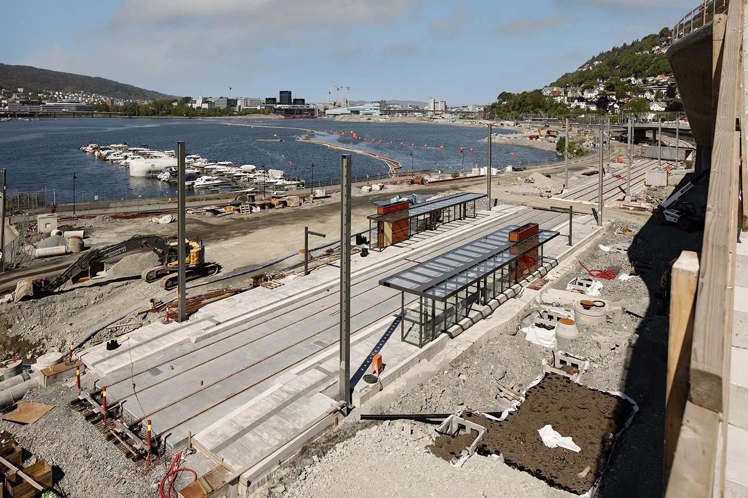 construction site near waterfront with buildings in background