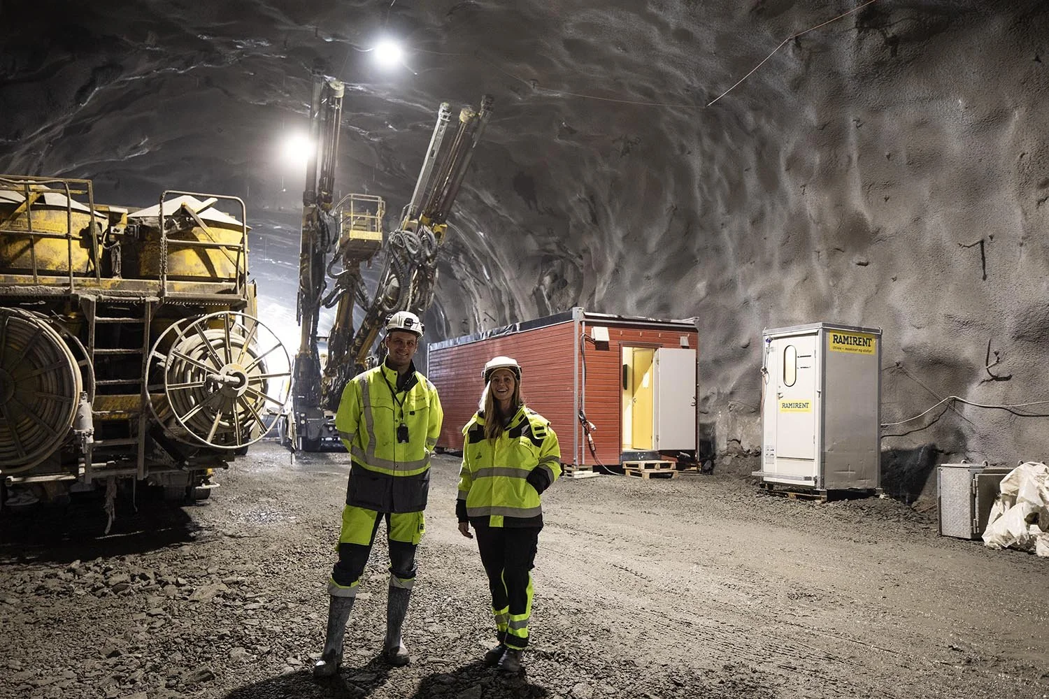 Underground tunnel construction site with machinery and workers